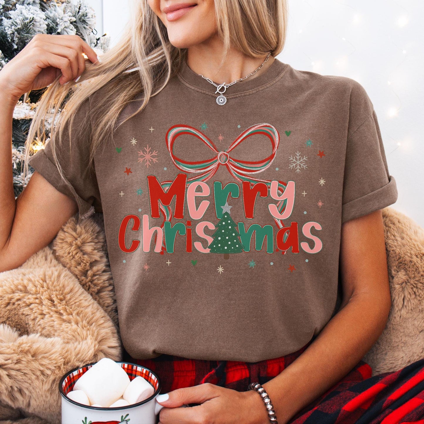 Preppy Merry Christmas Shirt on woman brown tee with bow and tree graphic cozy holiday mug