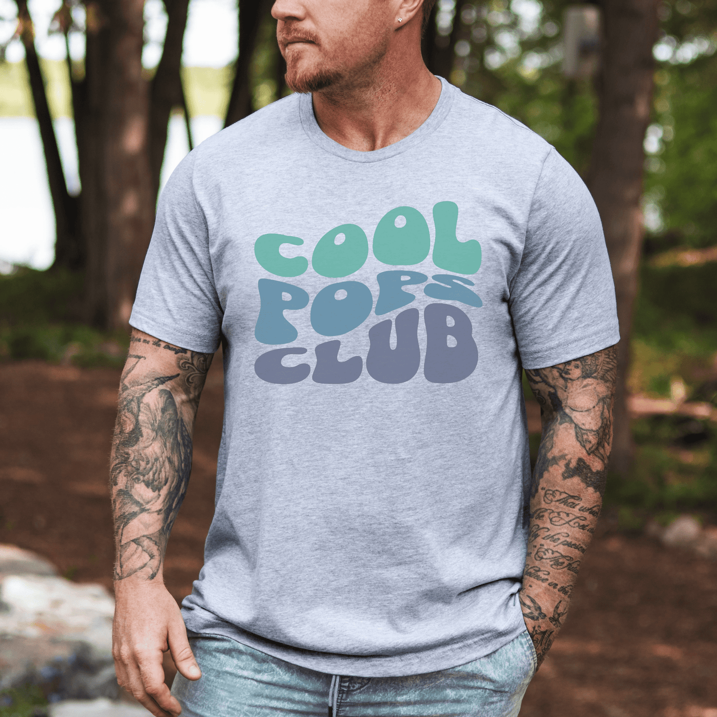 Male model wearing Maddy and George Designs Retro Cool Pops Club Shirt light gray tee with mint and blue bubble lettering