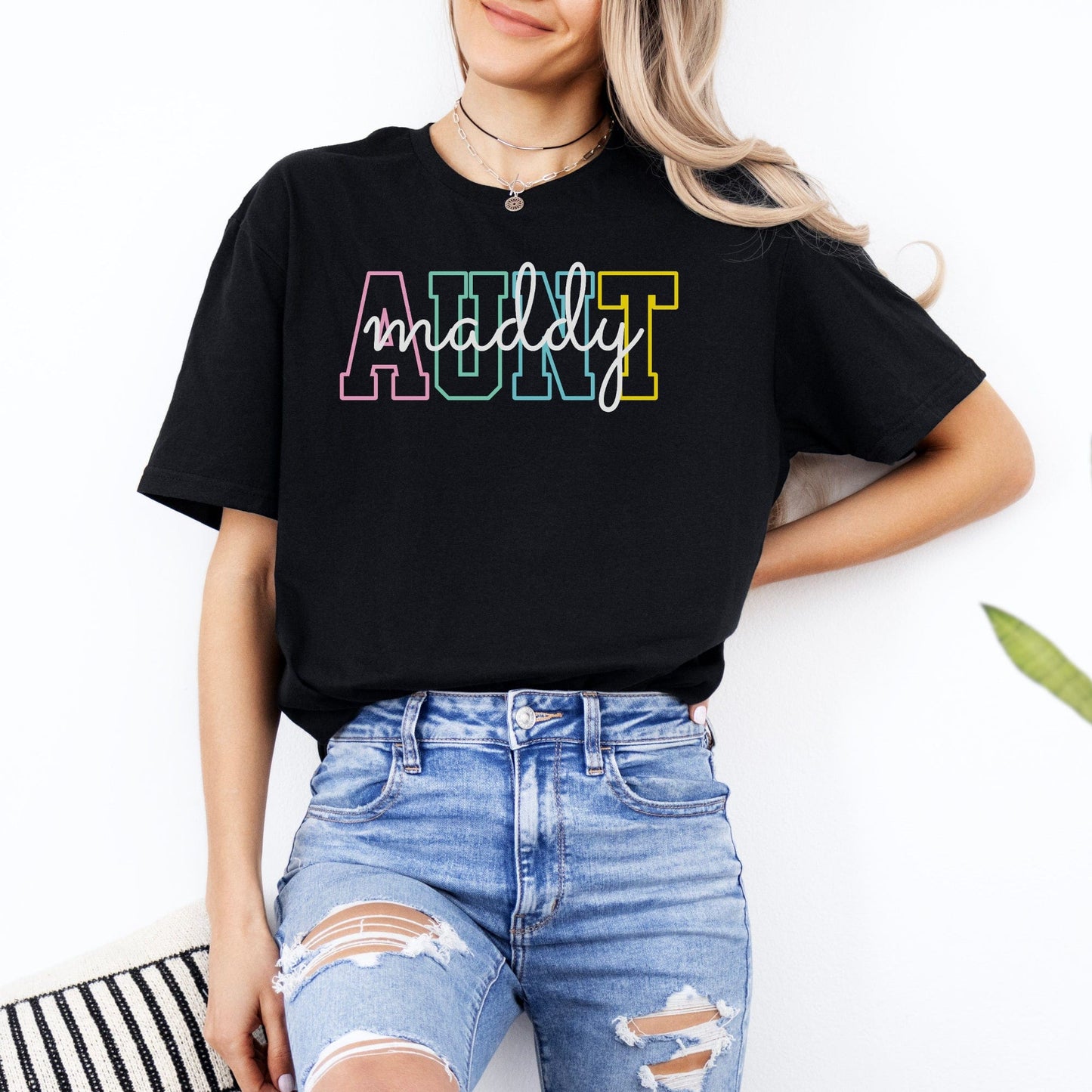 Black Custom Aunt Shirt with multicolor outlined AUNT letters and cursive maddy name by Maddy and George Designs