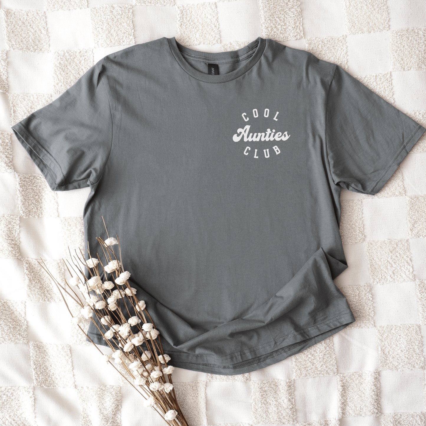 Gray crewneck shirt laid flat with white chest logo and cotton stems reading Cool Aunties Club Shirt .