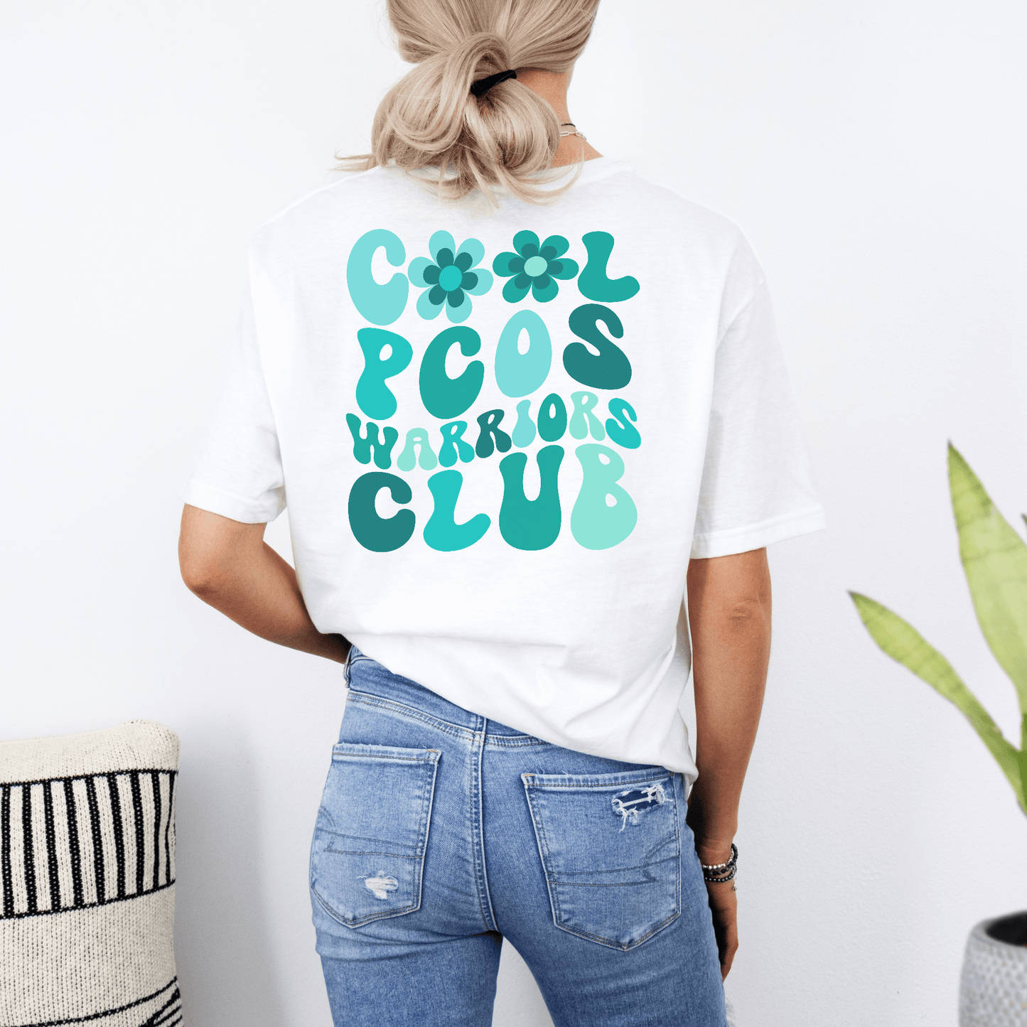 Rear view of woman wearing white PCOS Awareness Shirt with teal retro bubble Cool PCOS Warriors Club design
