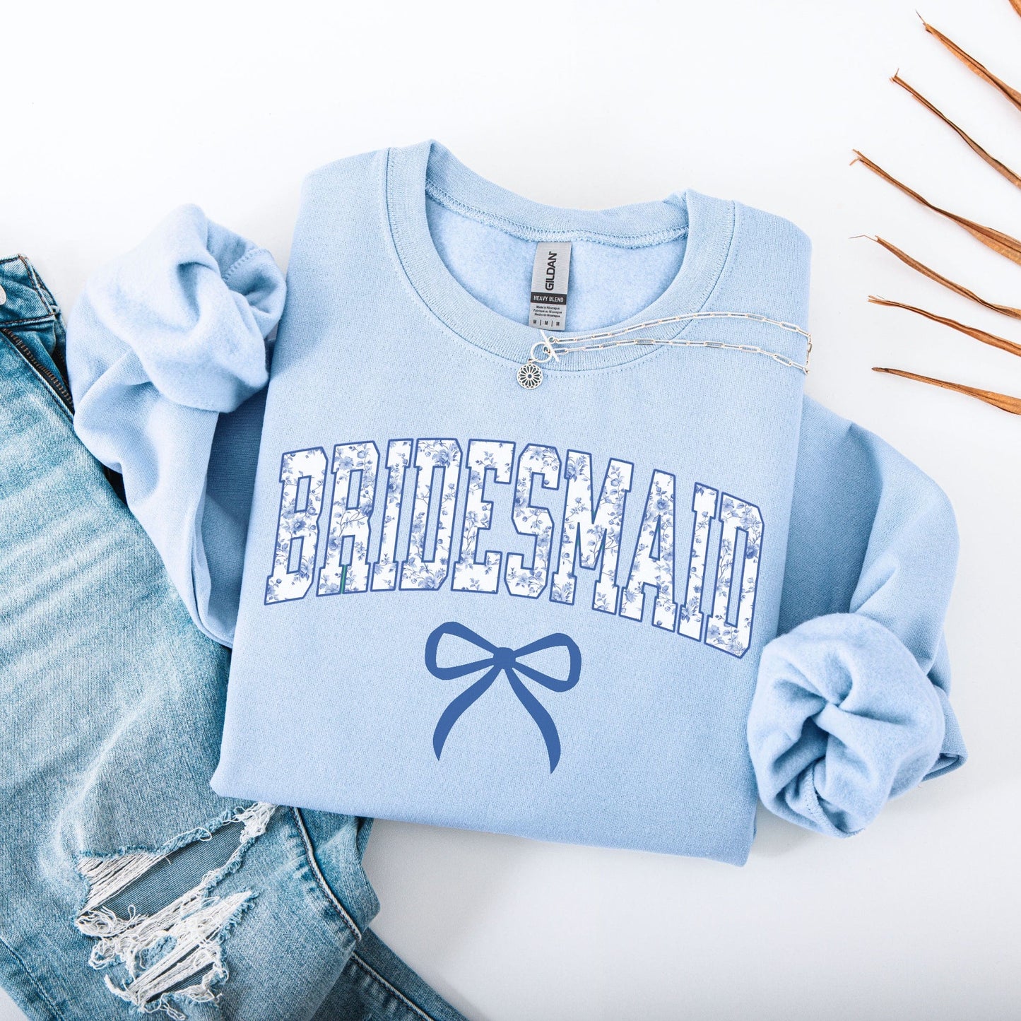 Chinoiserie Bridesmaid Sweatshirt Maddy and George Designs light blue folded crewneck with floral BRIDESMAID print and bow graphic