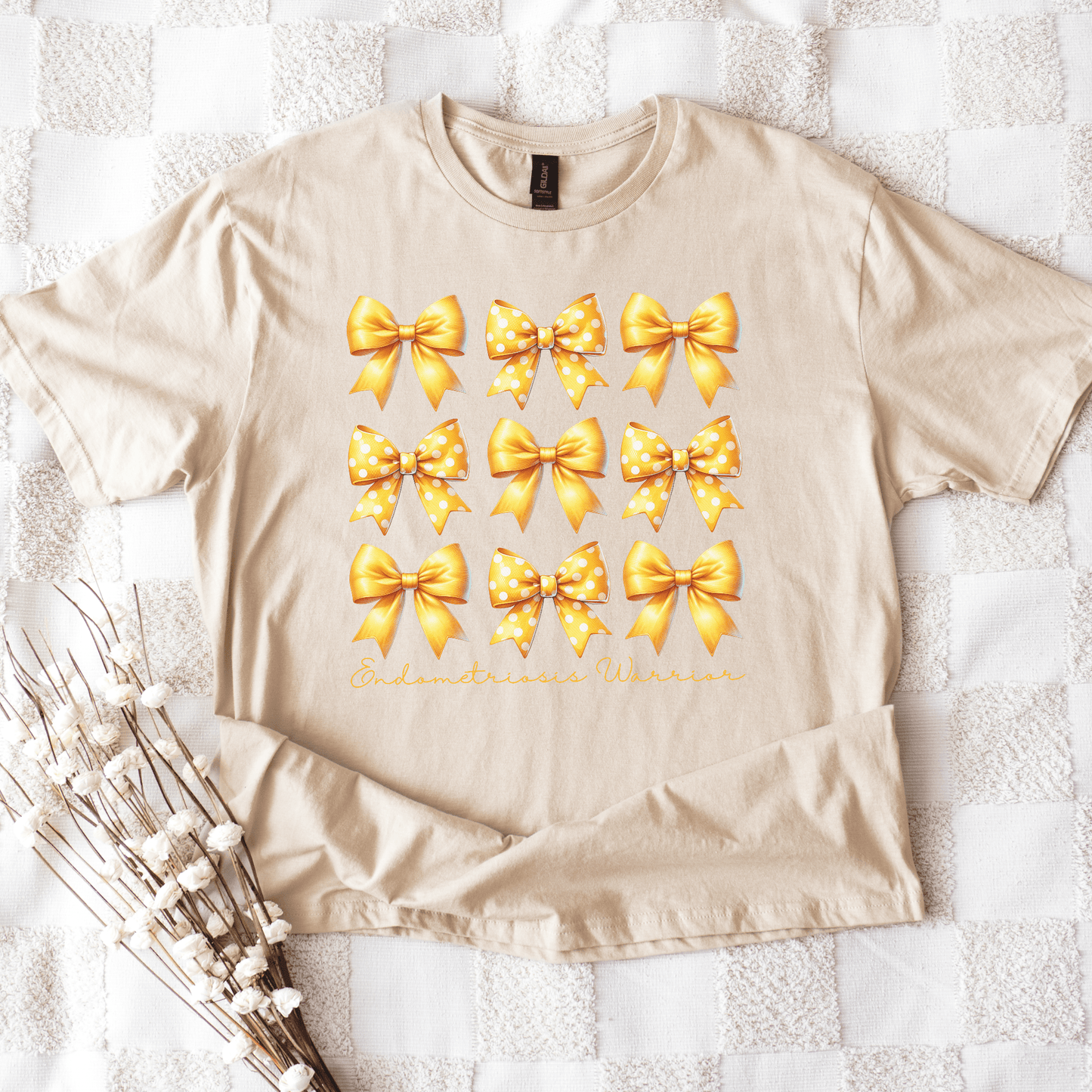 Coquette Endometriosis Awareness Shirt beige tee with nine yellow bows design and script Endometriosis Warrior