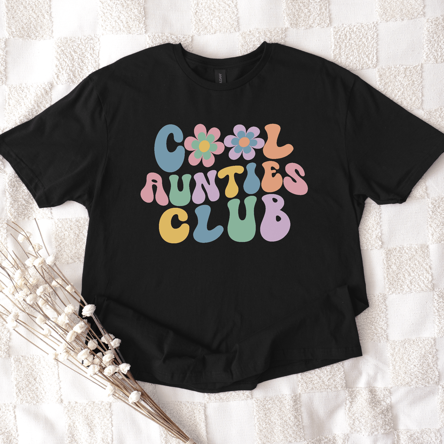 Black graphic tee with retro pastel bubble text Cool Aunties Club and flower motif by Maddy and George Designs cool aunt shirt