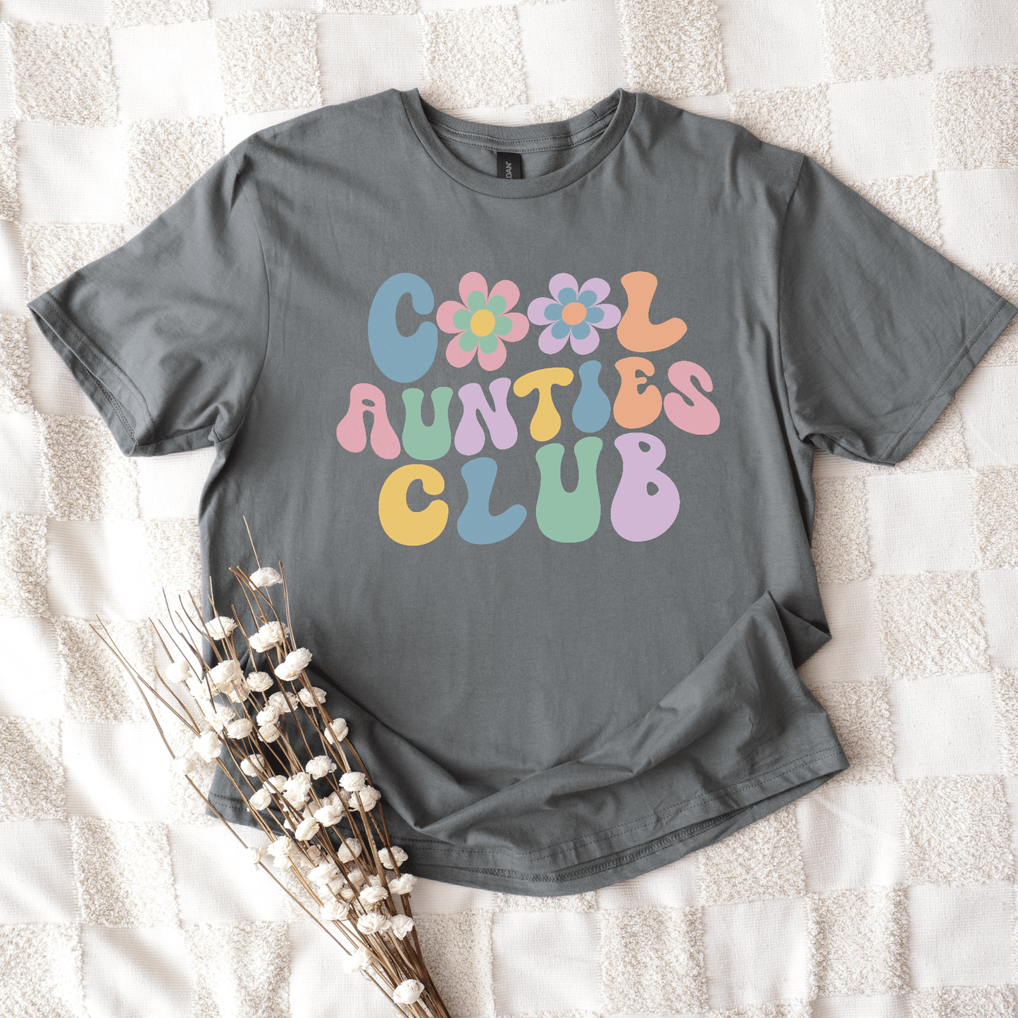 Gray flat lay tee with pastel retro flowers and bold Cool Aunties Club print by Maddy and George Designs cool aunt shirt
