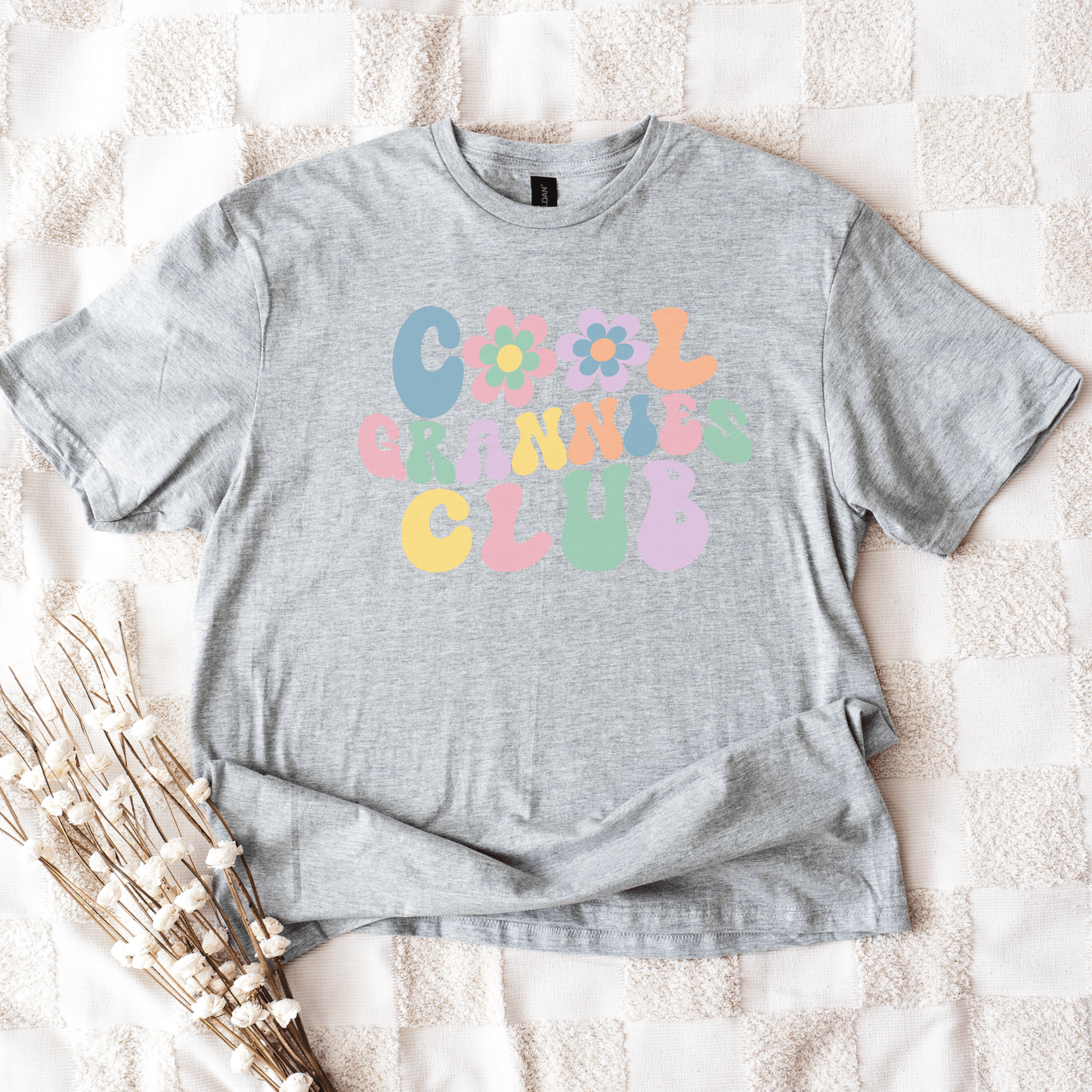 Cool Grannies Club Shirt by Maddy and George Designs gray cotton tee flatlay with pastel retro flower letters