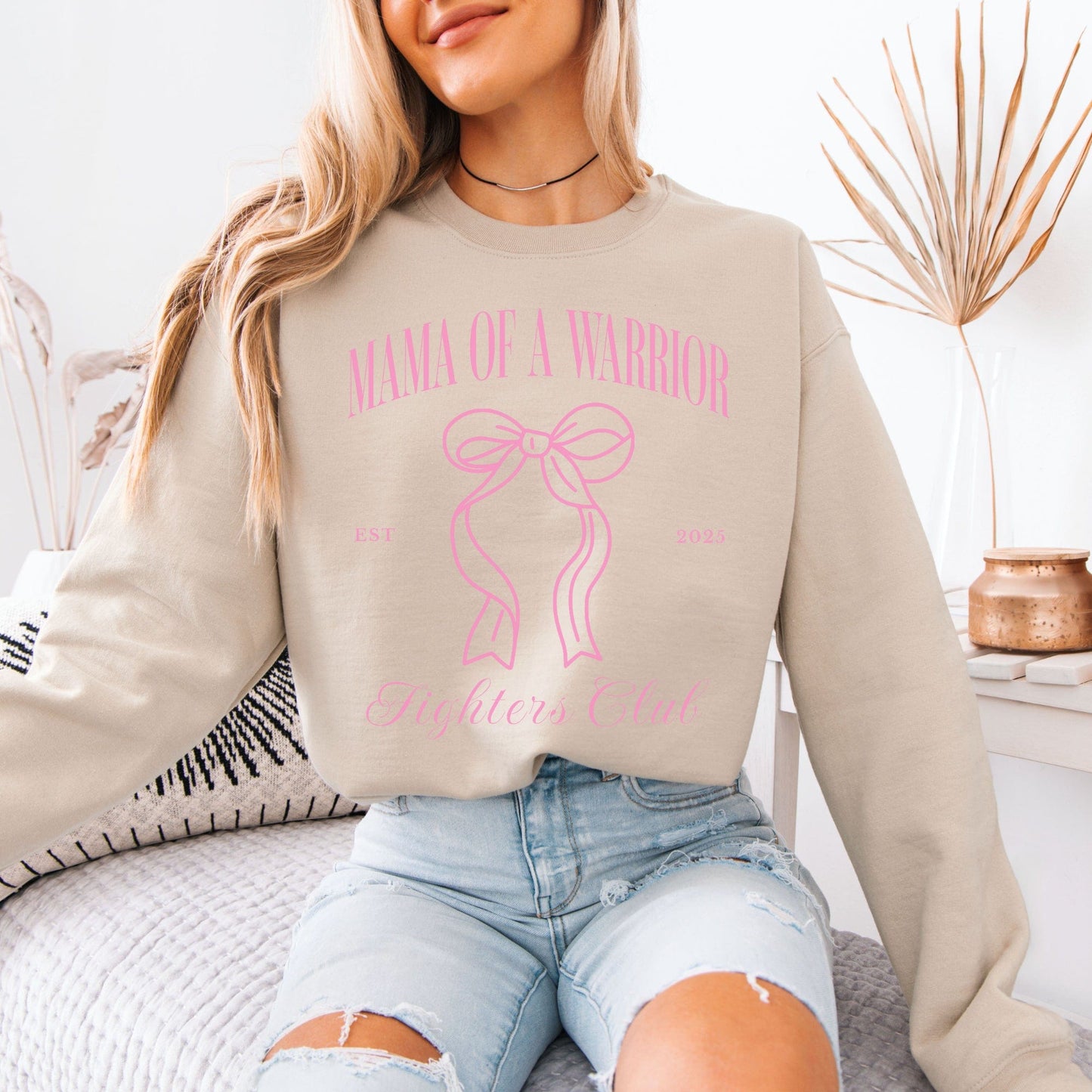 Maddy and George Designs beige sweatshirt with pink ribbon Mama of a Warrior print worn by model Medical Mom Gift