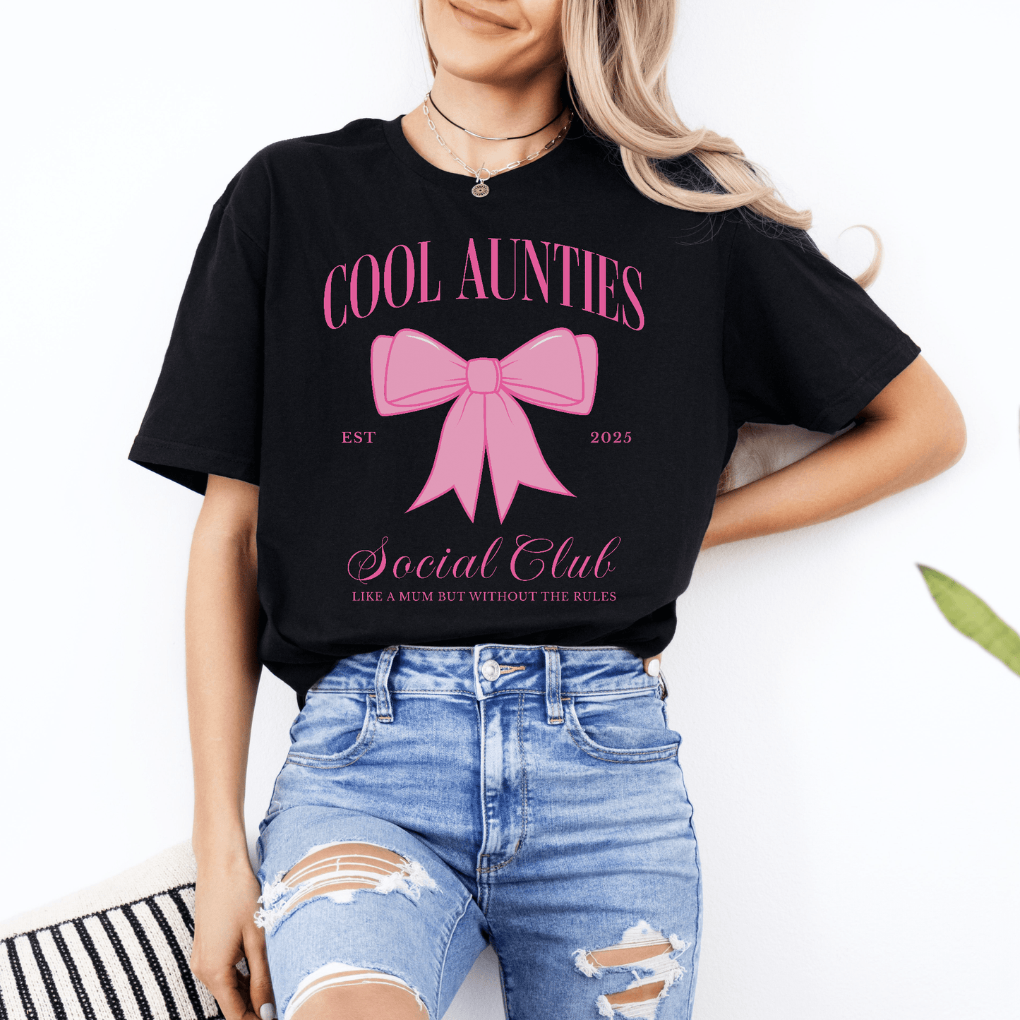 Custom Cool Aunties Club Shirt by Maddy and George Designs black tee with pink bow graphic and casual distressed jeans styling