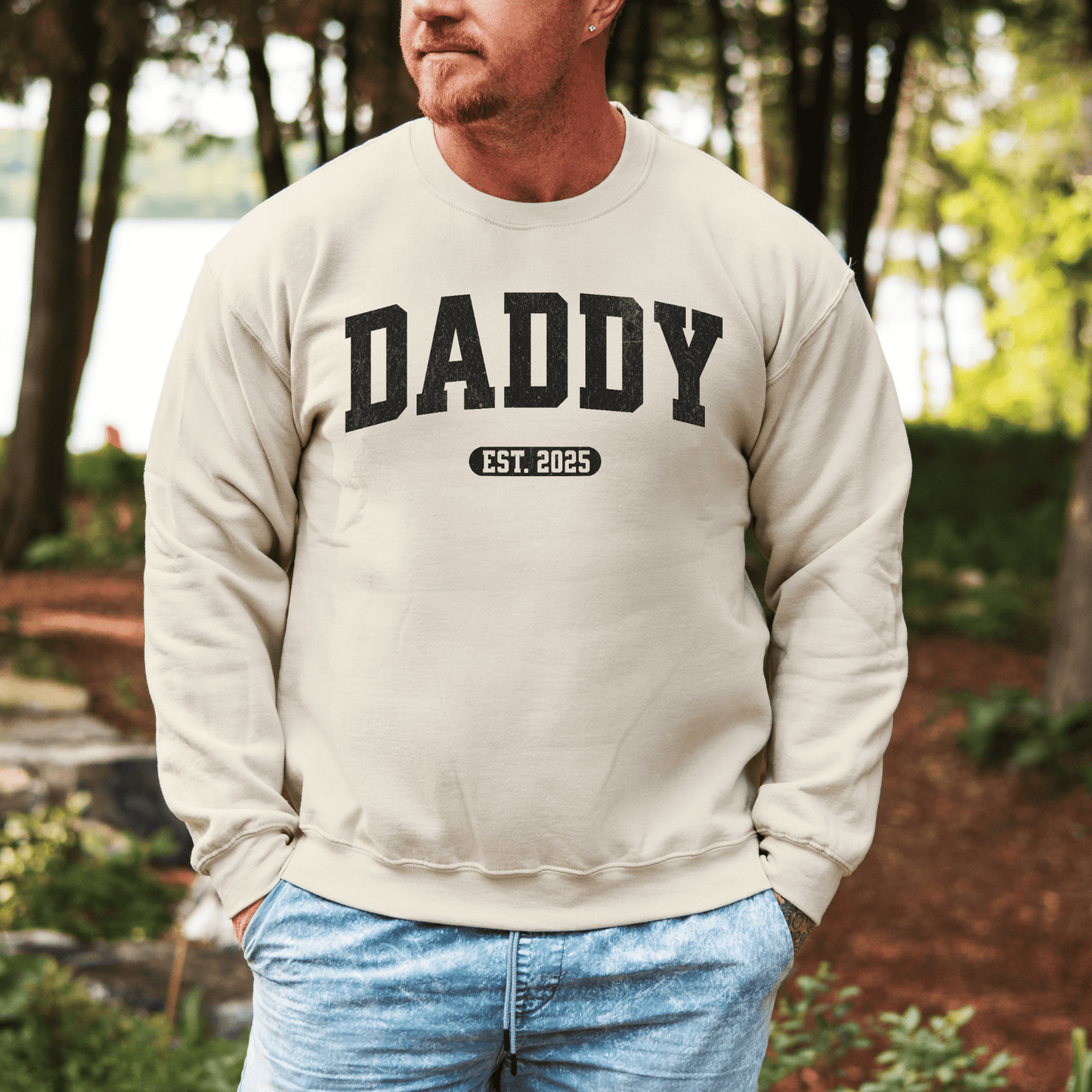 Maddy and George Designs Daddy Sweatshirt with Custom Year cream pullover showing DADDY and EST 2025 worn by man outdoors