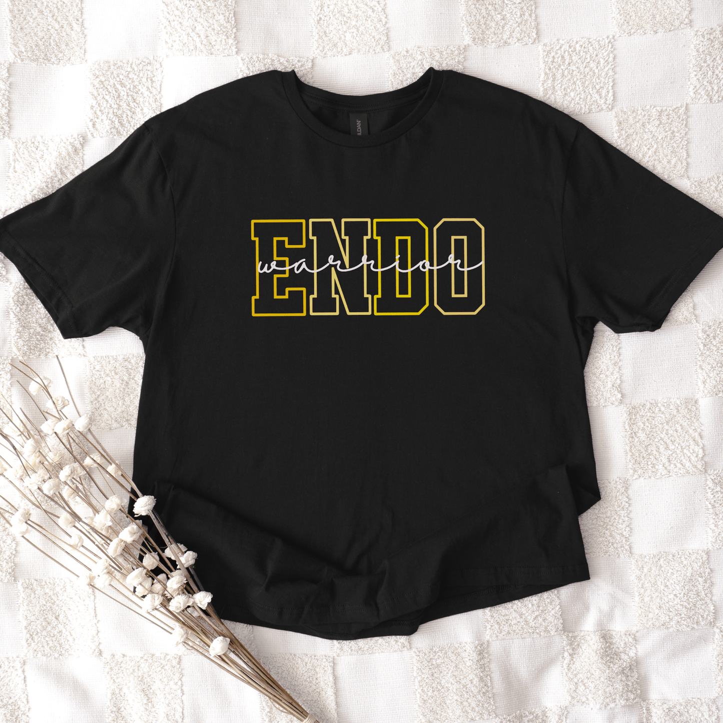Endometriosis Awareness Shirt | Gift For Endo Warrior black tee with bold yellow outlined ENDO letters laid flat