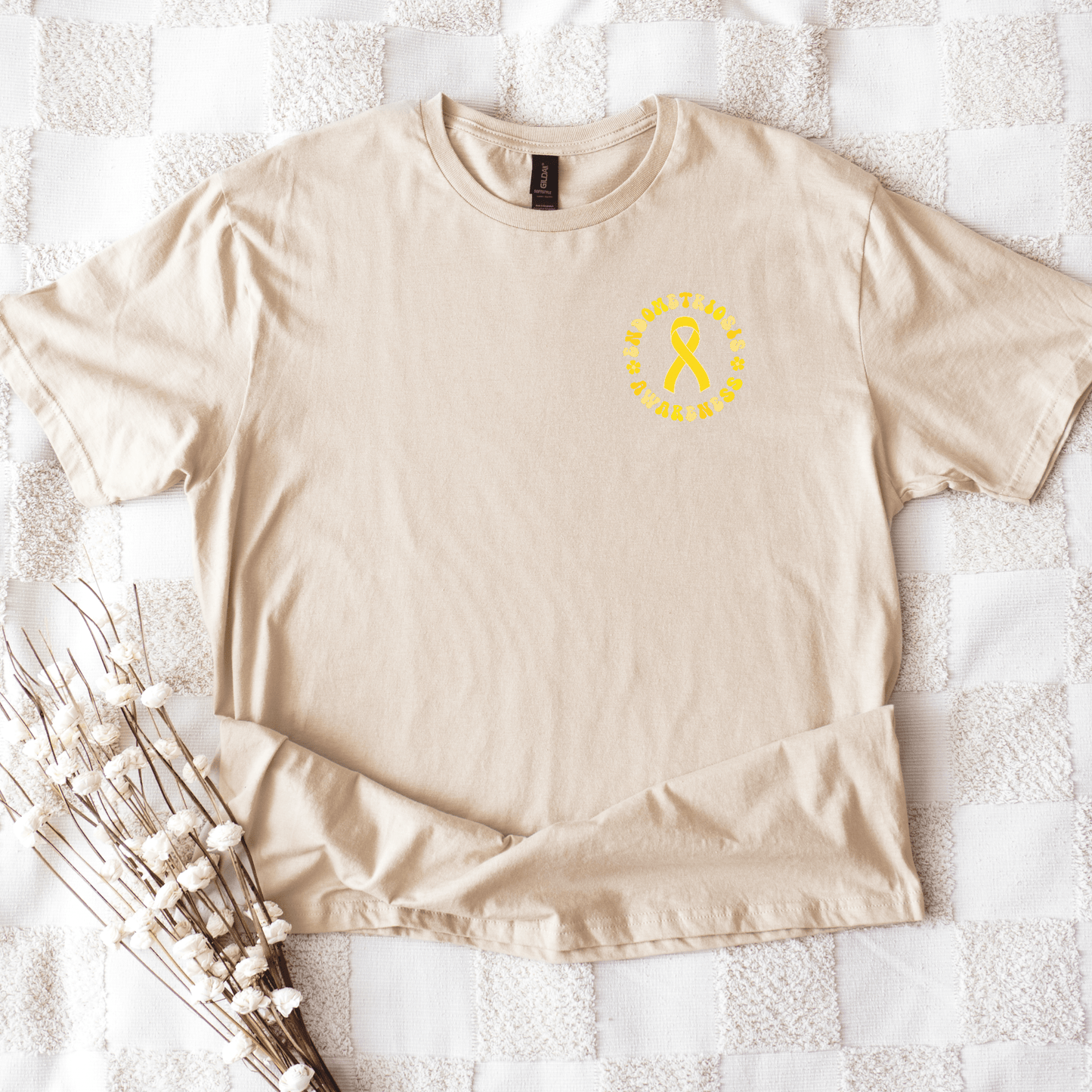 Endo Warrior Shirt | Endometriosis Awareness Gift beige tee flat lay with small yellow ribbon chest print