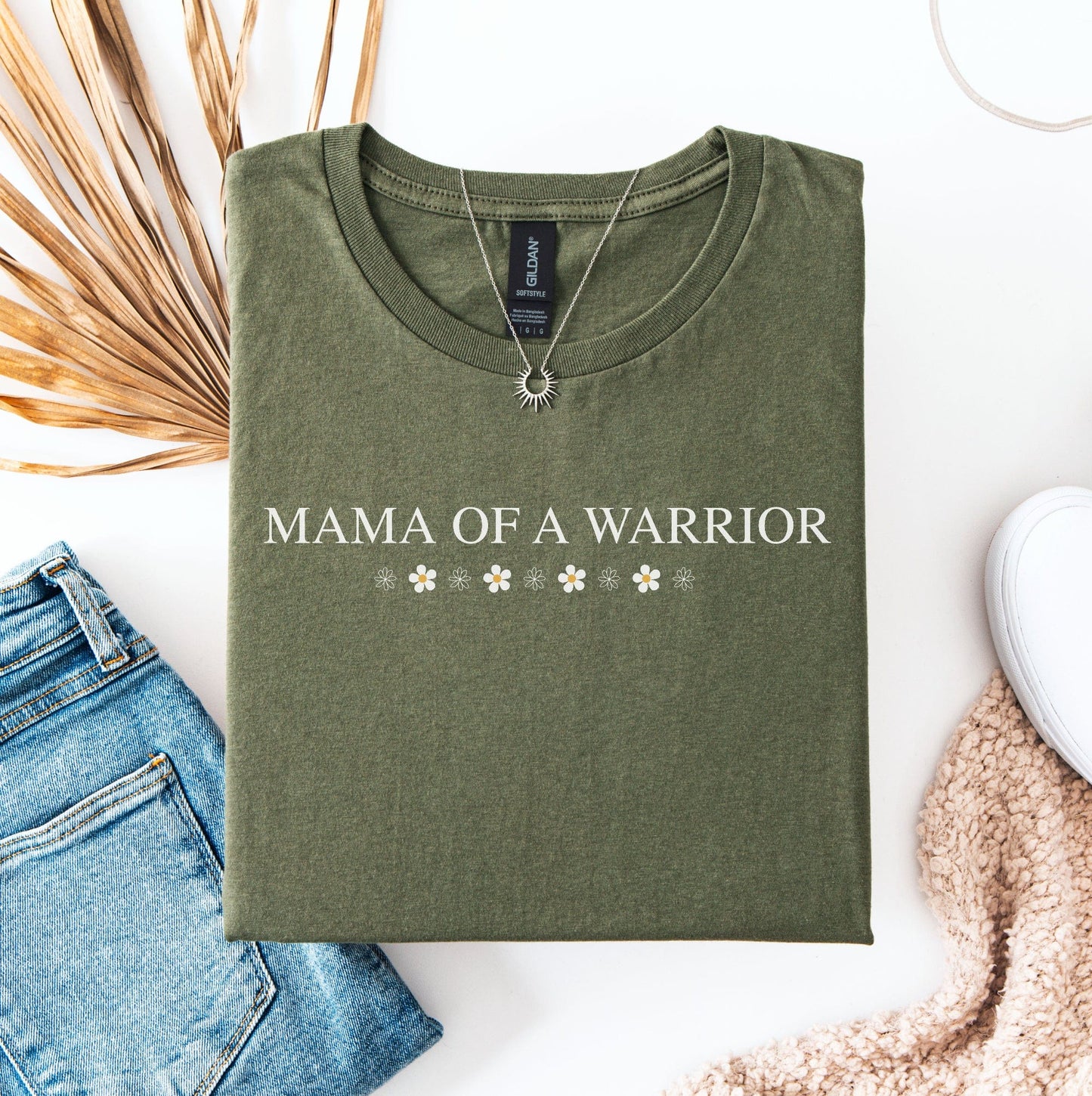 Mama Of A Warrior Shirt olive green folded tee with white lettering and floral accents styled with jeans