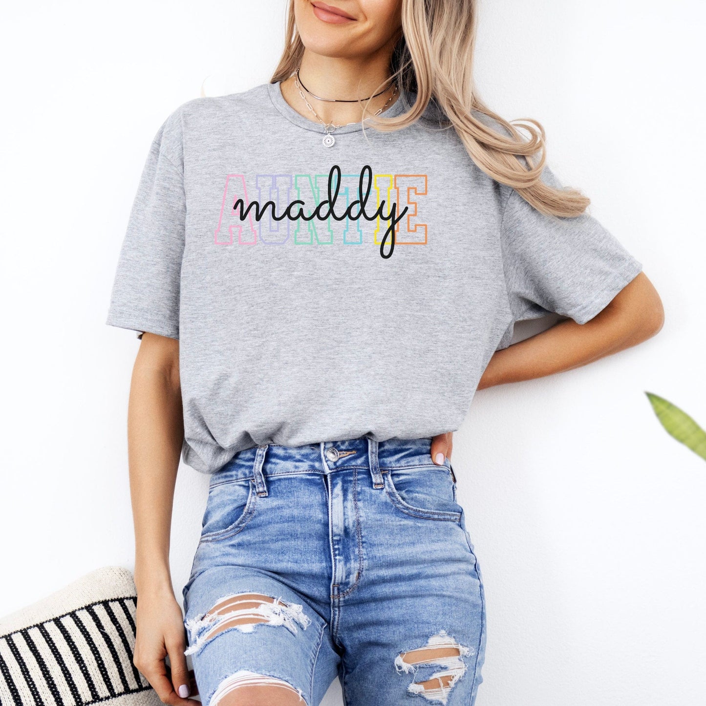 Gray tshirt with pastel AUNTIE block letters and cursive maddy print worn with ripped jeans Custom Auntie Shirt