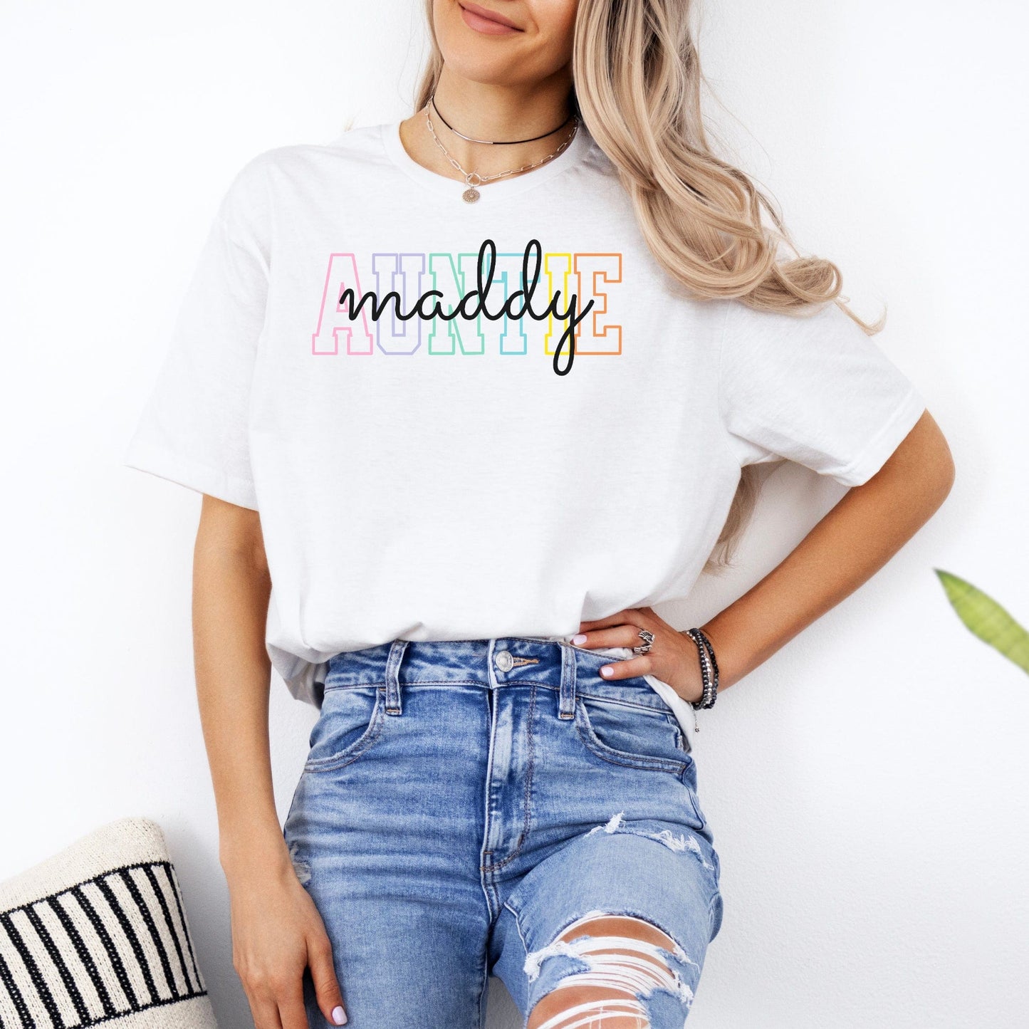 Woman wearing Maddy and George Designs Custom Auntie Shirt white tee with colorful AUNTIE lettering and script name casual outfit