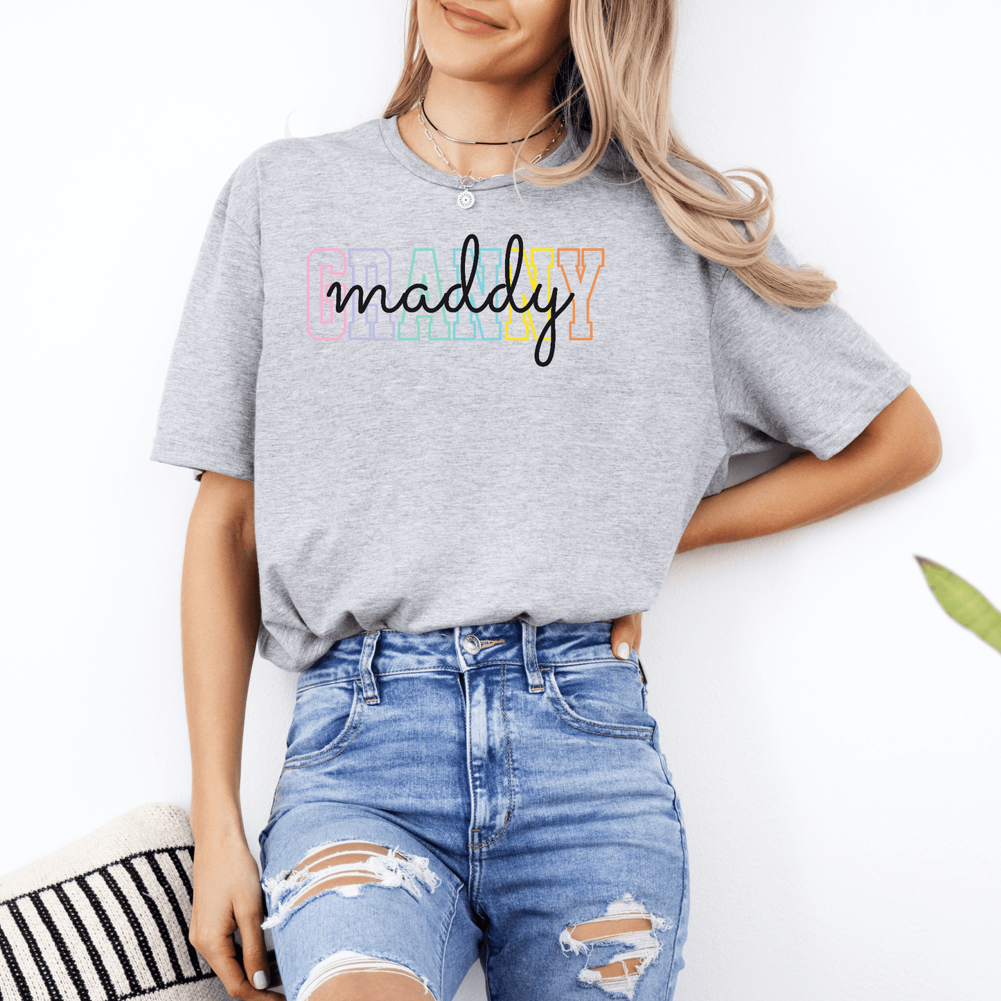Gray tee by Maddy and George Designs Custom Granny Shirt with colorful block letters and script name, worn with ripped jeans