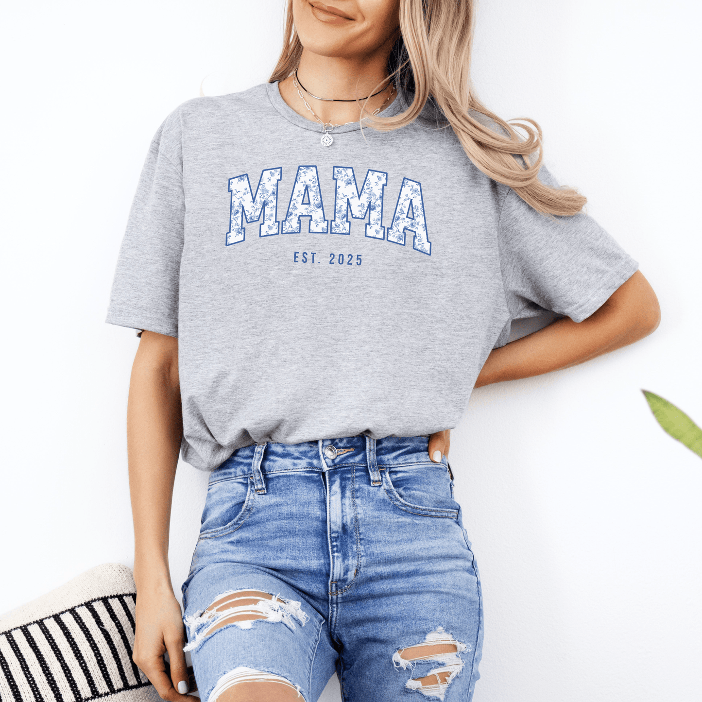 Woman wearing gray Custom Mama Est. Year Shirt by Maddy and George Designs featuring distressed blue MAMA print