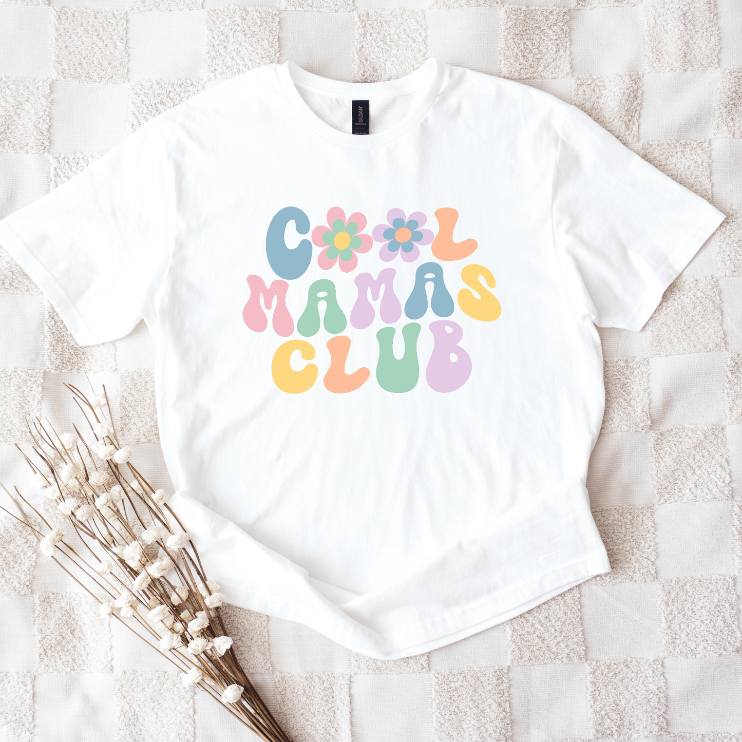 White tee with pastel retro bubble letters and flowers reading Cool Mamas Club Shirt by Maddy and George Designs