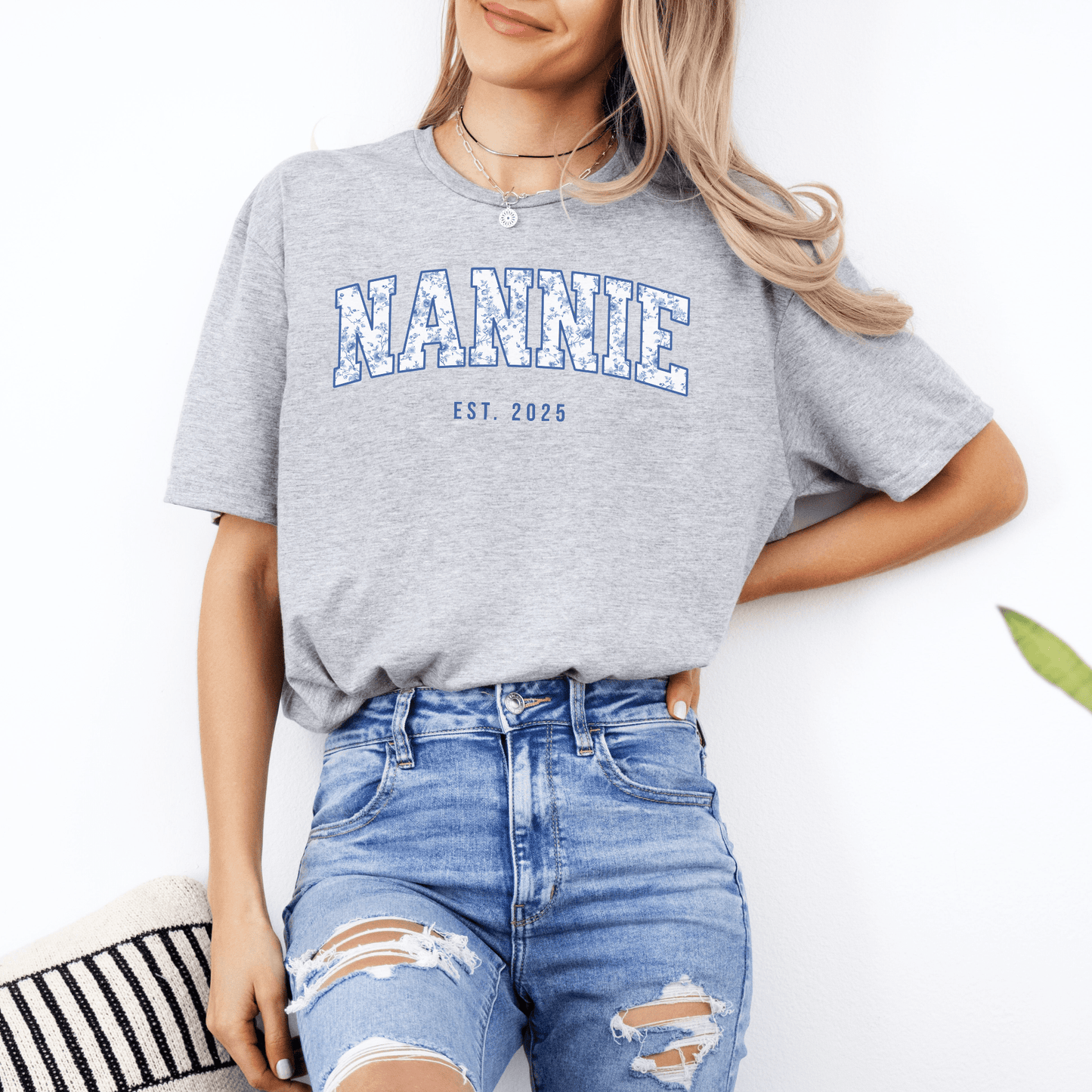 Custom Nannie Est. Year Shirt . Gray t shirt with blue collegiate NANNIE print modeled with ripped jeans