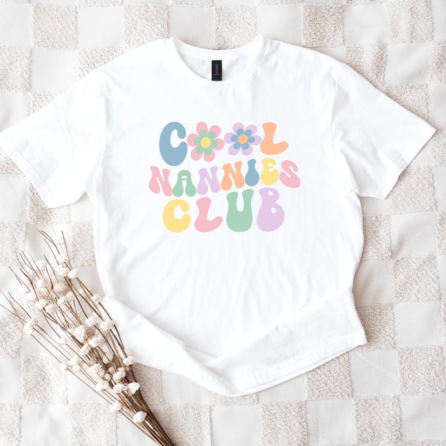 Cool Nannies Club Shirt white tee with pastel retro bubble letters and floral icons nanny gift
