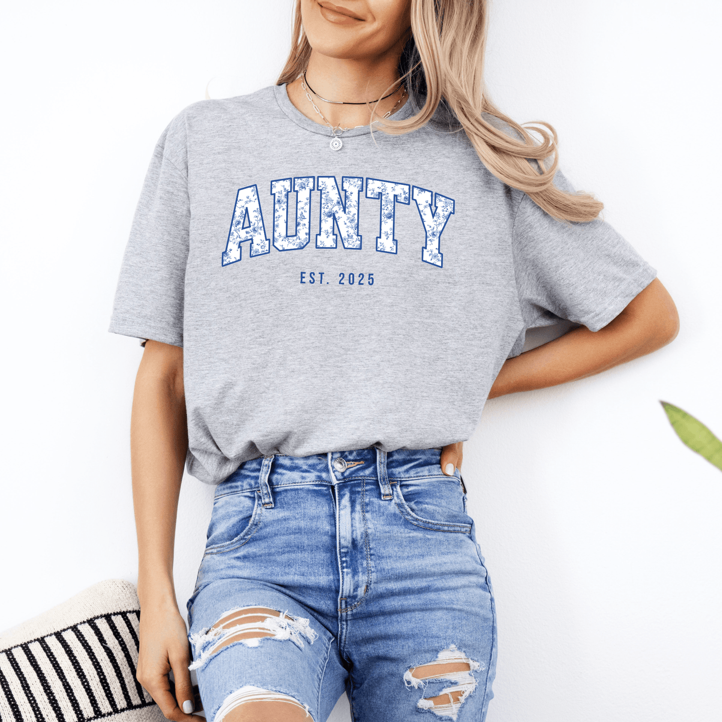 Woman wearing grey Custom Aunty Est. Year Shirt . with blue varsity AUNTY print and distressed jeans casual outfit