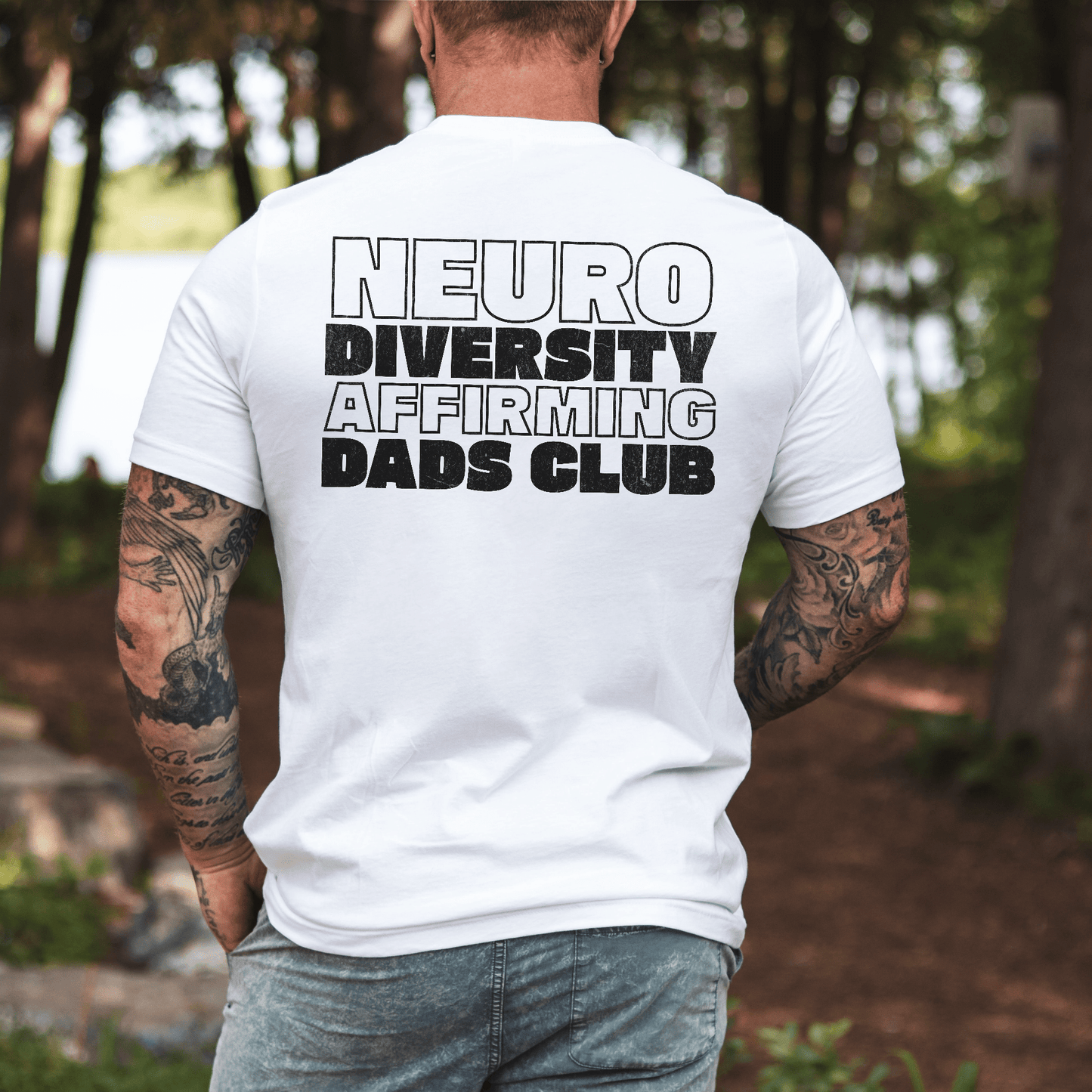 Back view of man wearing white Neurodiversity Affirming Dads Club Shirt . with bold black text design by Maddy and George Designs