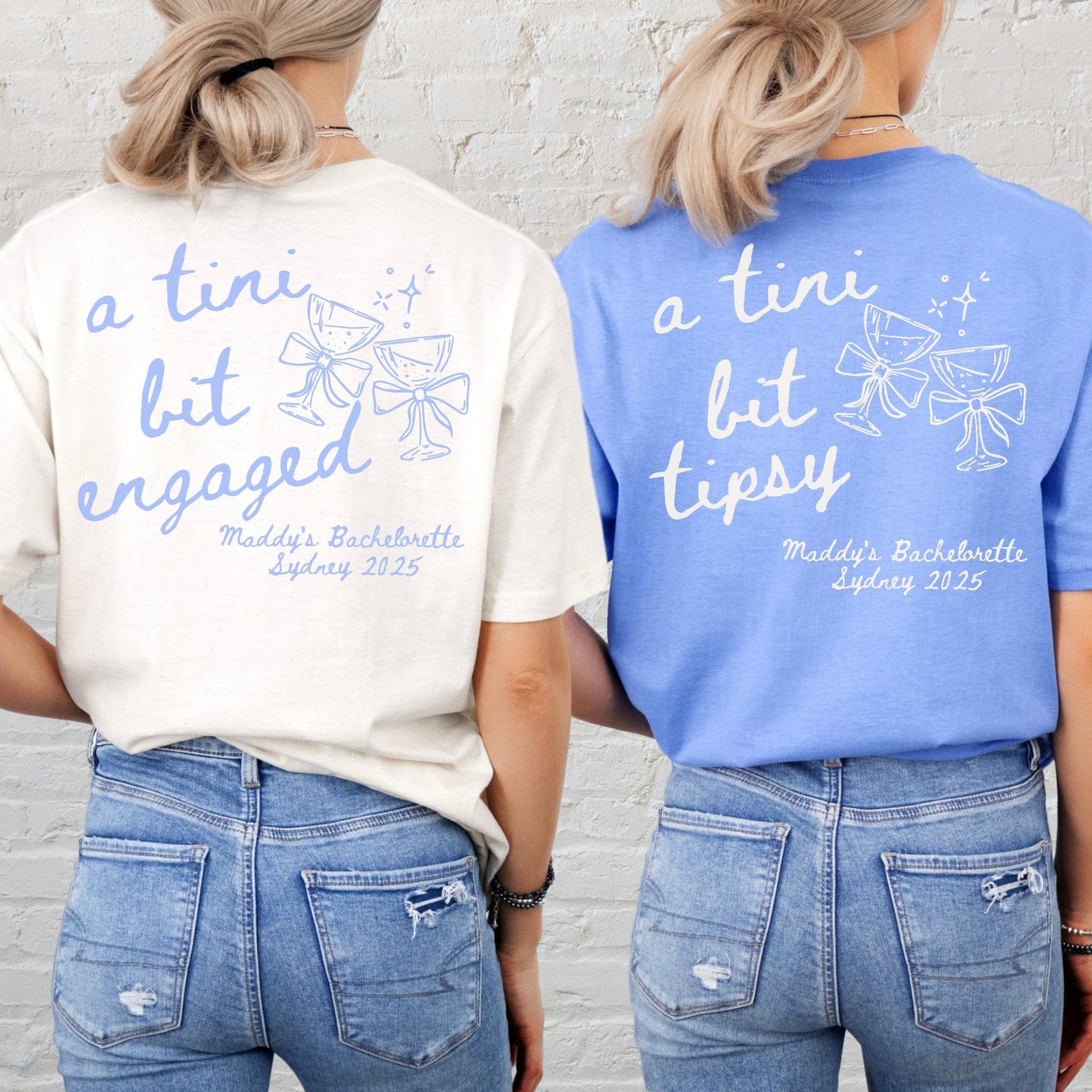 Two women wearing Martini Bachelorette Shirts Maddy and George Designs cream and blue tees with martini glass graphics on back