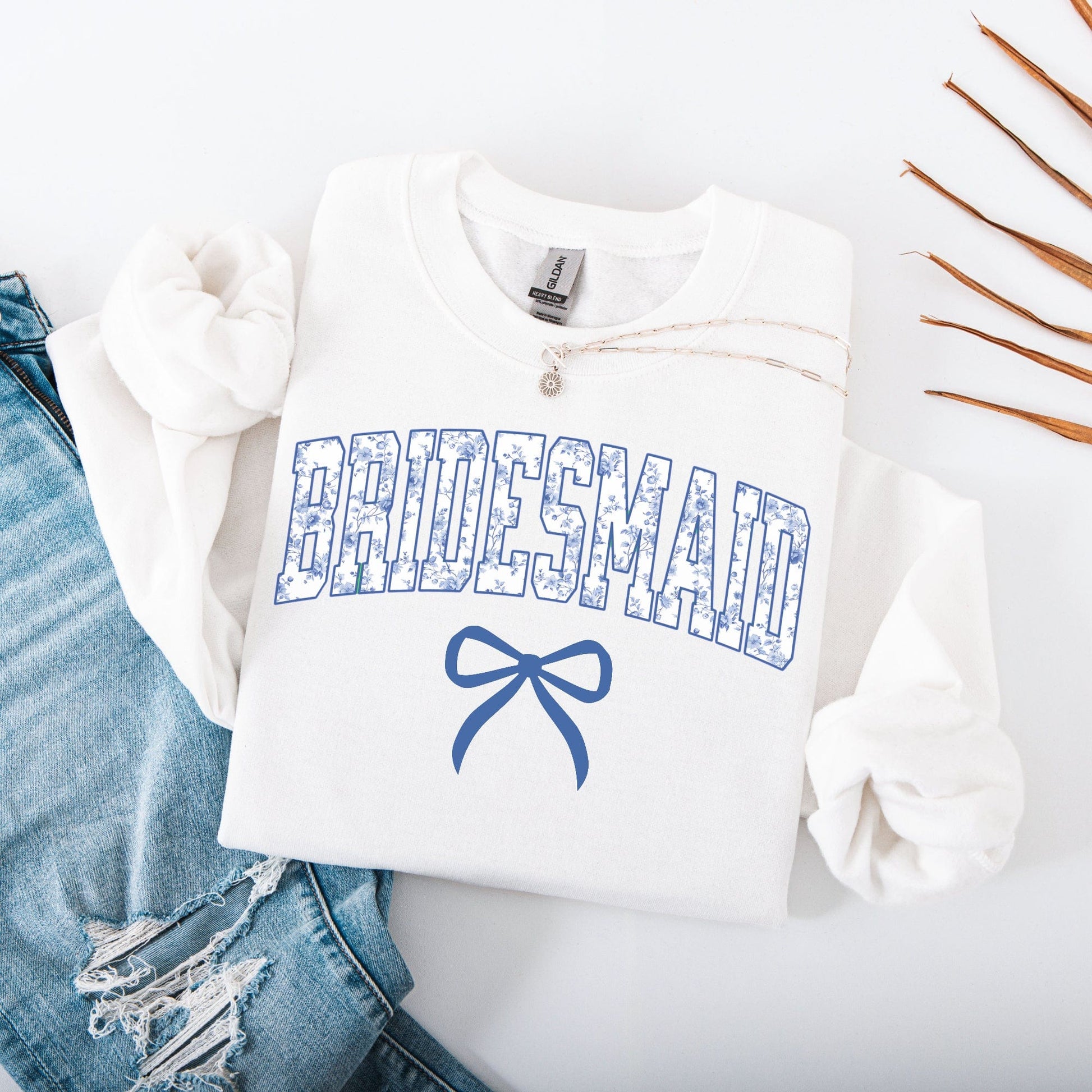 Chinoiserie Bridesmaid Sweatshirt folded white crewneck with blue floral BRIDESMAID print and bow
