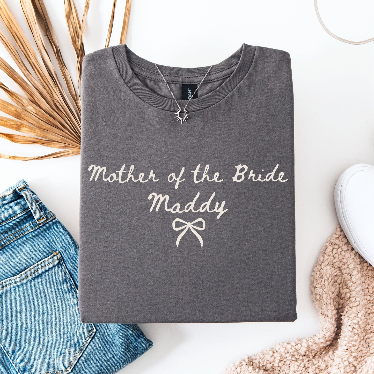 Gray folded Custom Mother of the Bride Shirt with personalized name Maddy script and bow graphic