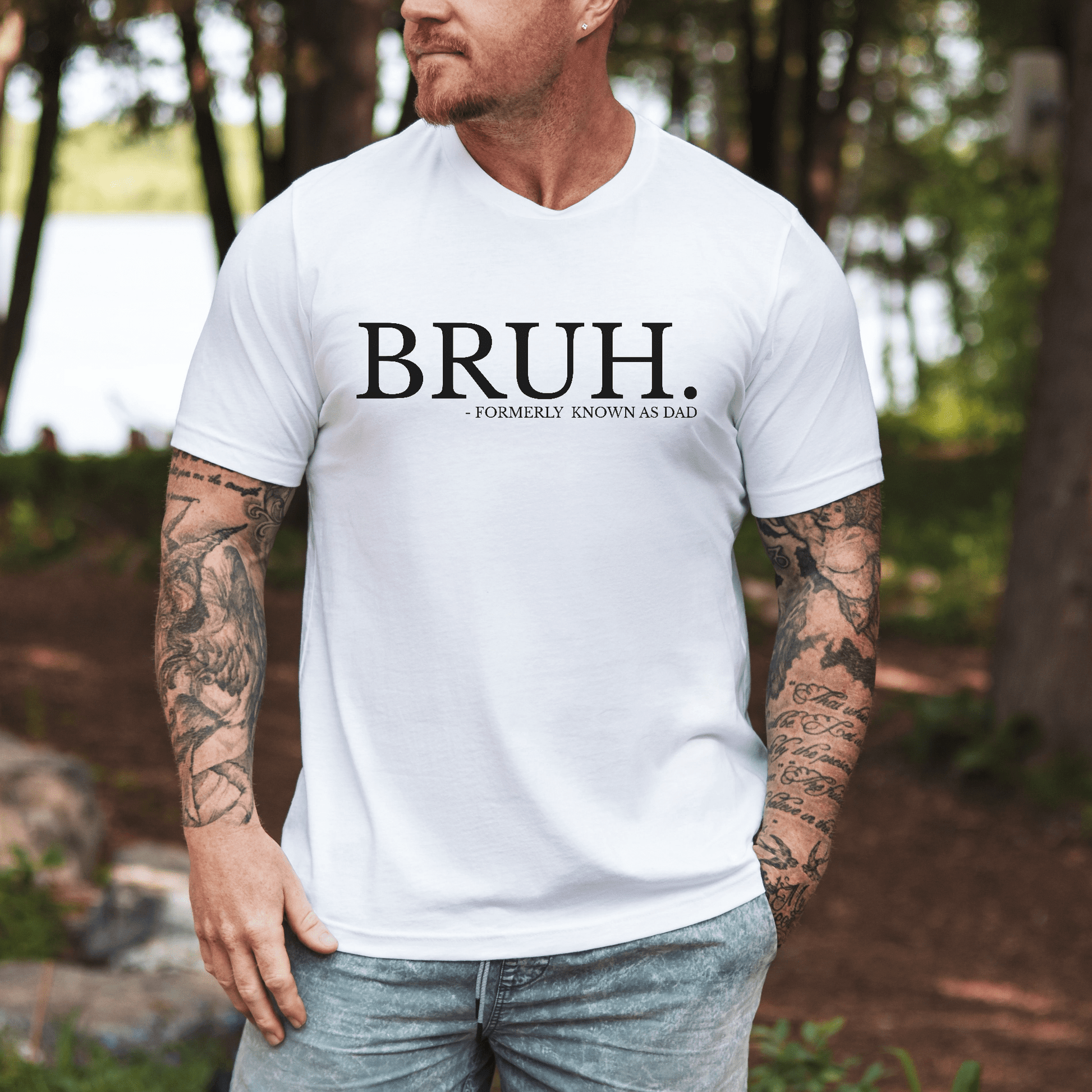 Male model wearing white BRUH Formally Known As Dad Shirt printed on chest casual outdoors