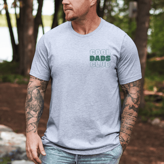Maddy and George Designs Cool Dads Club Shirt | New Dad Gift light gray cotton tee with small chest logo worn by dad outdoors