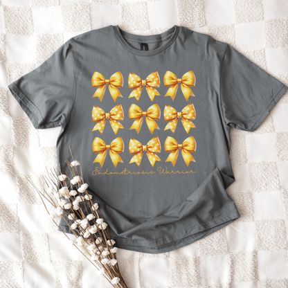 Coquette Endometriosis Awareness Shirt gray tee with nine golden bows in grid and script Endometriosis Warrior