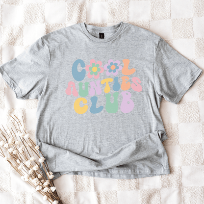 Gray unisex tee with pastel bubble letters and flowers reading COOL AUNTIES CLUB cool aunt shirt by Maddy and George Designs