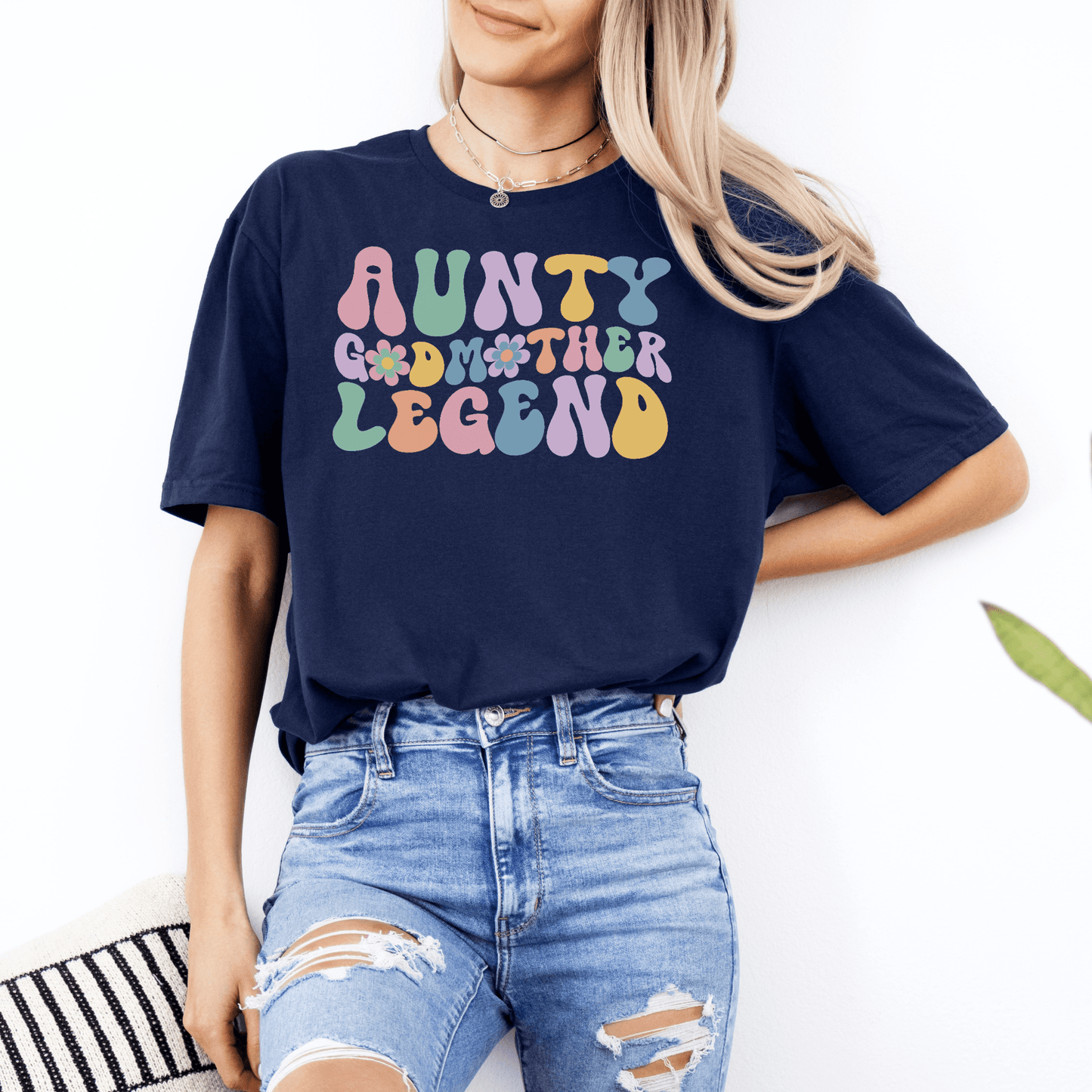 Woman wearing navy casual tee with colorful retro typography aunty godmother legend shirt ideal gift