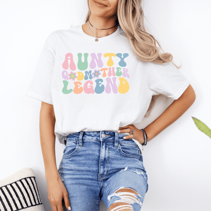 Female model wearing white tee with pastel retro floral lettering aunty godmother legend shirt by Maddy and George Designs