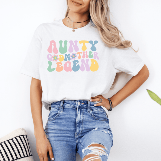 Female model wearing white tee with pastel retro floral lettering aunty godmother legend shirt by Maddy and George Designs