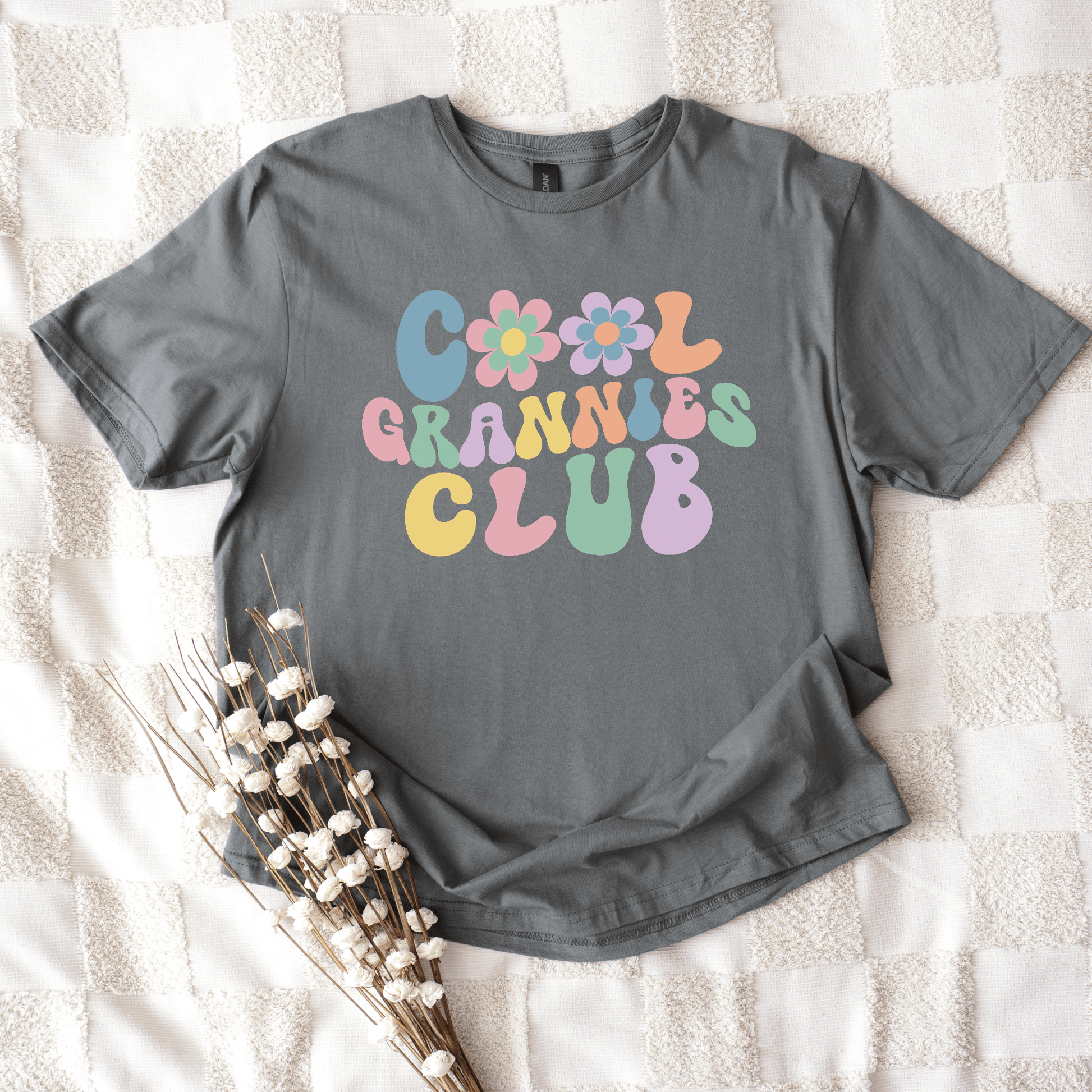 Cool Grannies Club Shirt grey tee with pastel retro bubble letters and floral accents flat lay by Maddy and George Designs