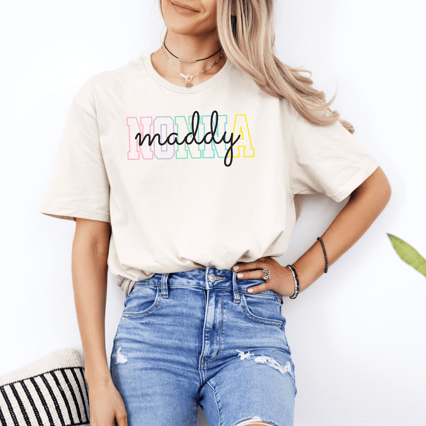 Woman wearing cream Custom Nonna Shirt with pastel NONNA letters and personalized maddy script by Maddy and George Designs