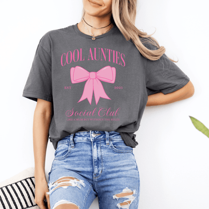 Woman wearing Custom Cool Aunties Club Shirt gray tee with pink bow graphic styled with ripped jeans