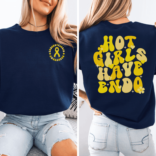 Hot Girls Have Endo Sweatshirt navy crewneck with small yellow endometriosis ribbon on front and bold retro back print on model