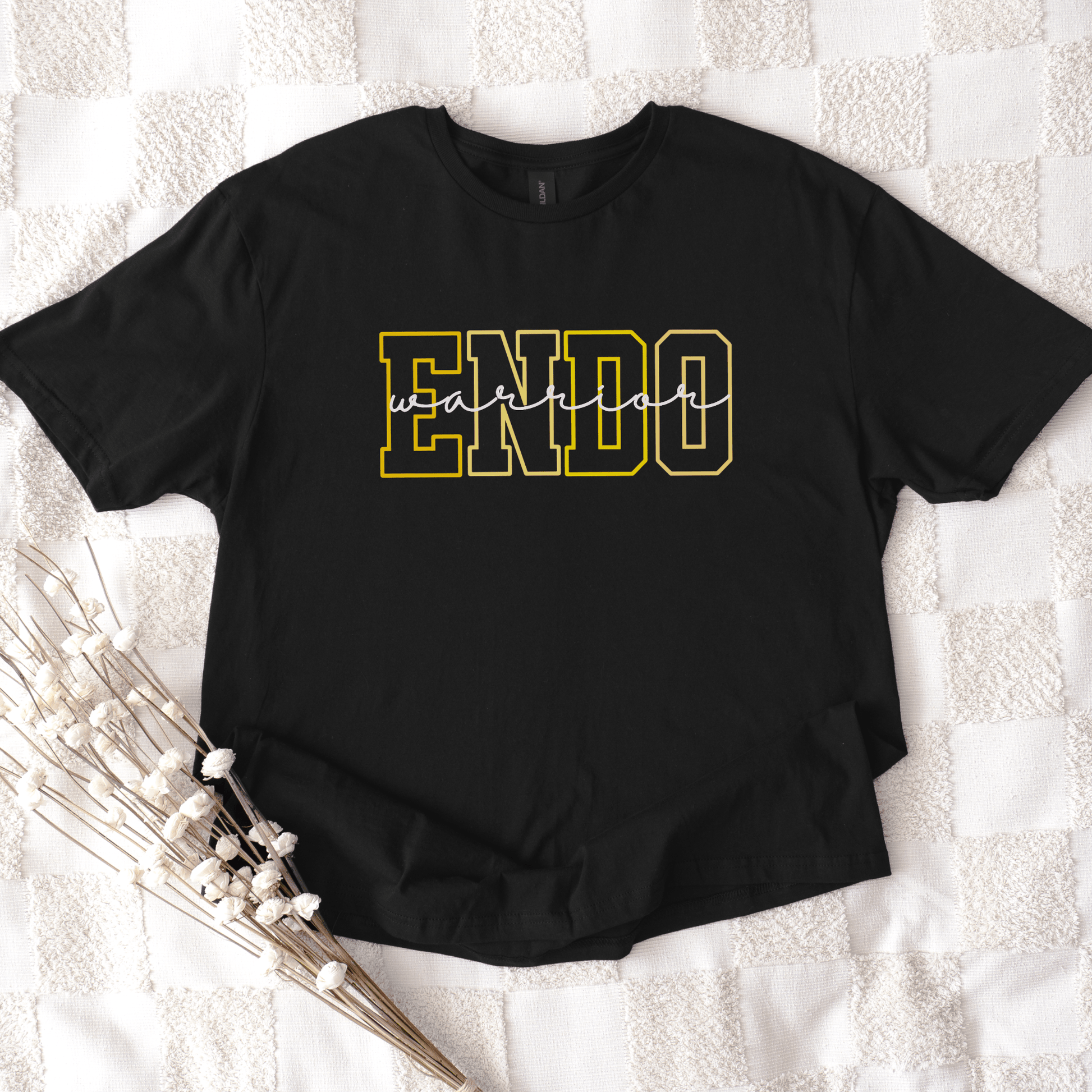Endometriosis Awareness Shirt | Gift For Endo Warrior black tee with bold yellow outlined ENDO letters laid flat