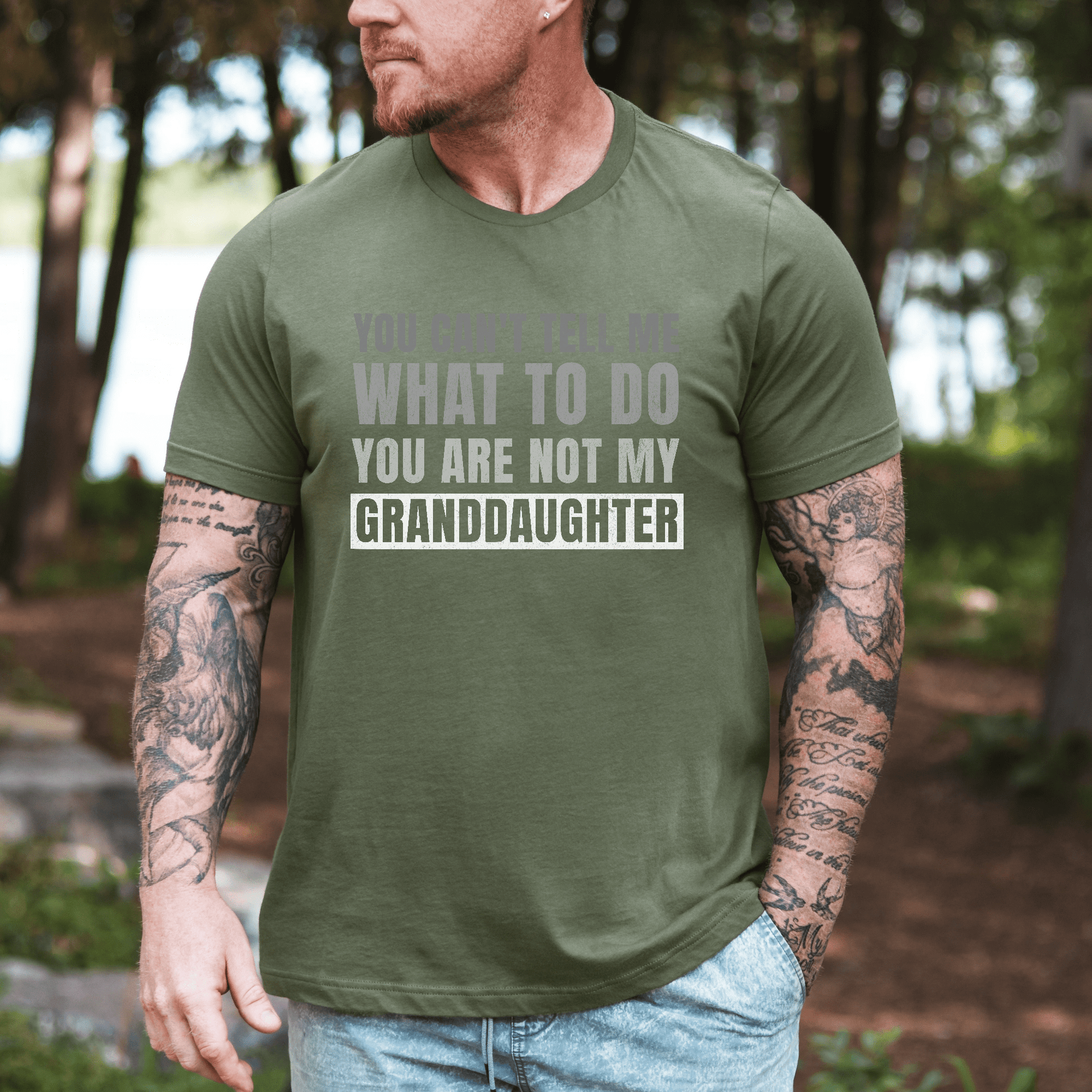 Maddy and George Designs Funny Grandpa Shirt olive green tee with granddaughter slogan worn by tattooed man outdoors