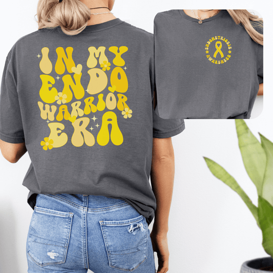 Endometriosis Awareness Shirt . Grey tee with yellow retro floral IN MY ENDO WARRIOR ERA and chest ribbon logo