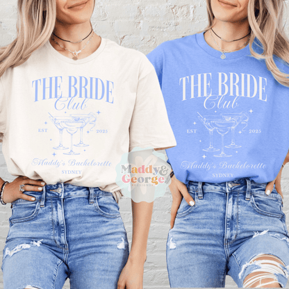 Custom Bachelorette Party Tee featuring The Bride Club graphic on cream and blue shirts worn by two women in jeans