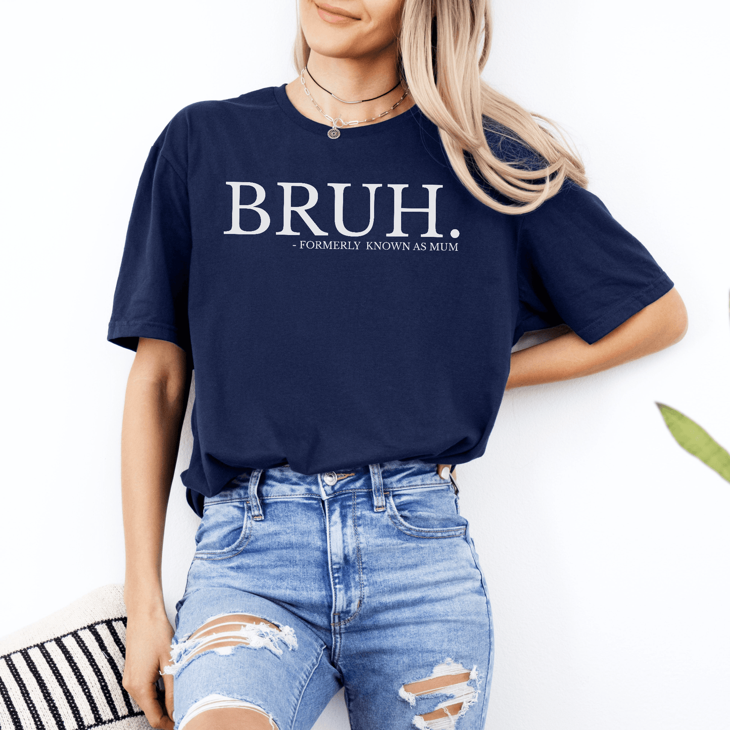 Woman wearing navy tee with Bruh. Formerly Known as Mum Shirt. white text across chest paired with ripped jeans