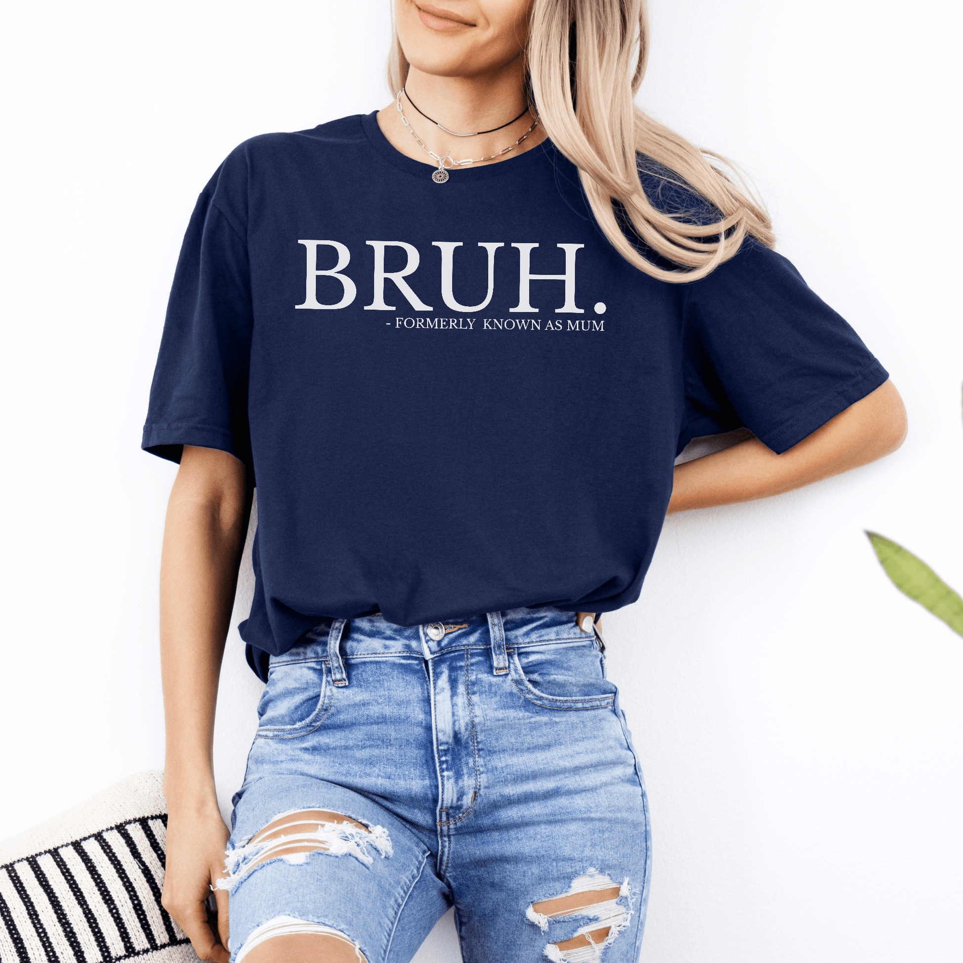 Woman wearing navy tee with Bruh. Formerly Known as Mum Shirt. white text across chest paired with ripped jeans