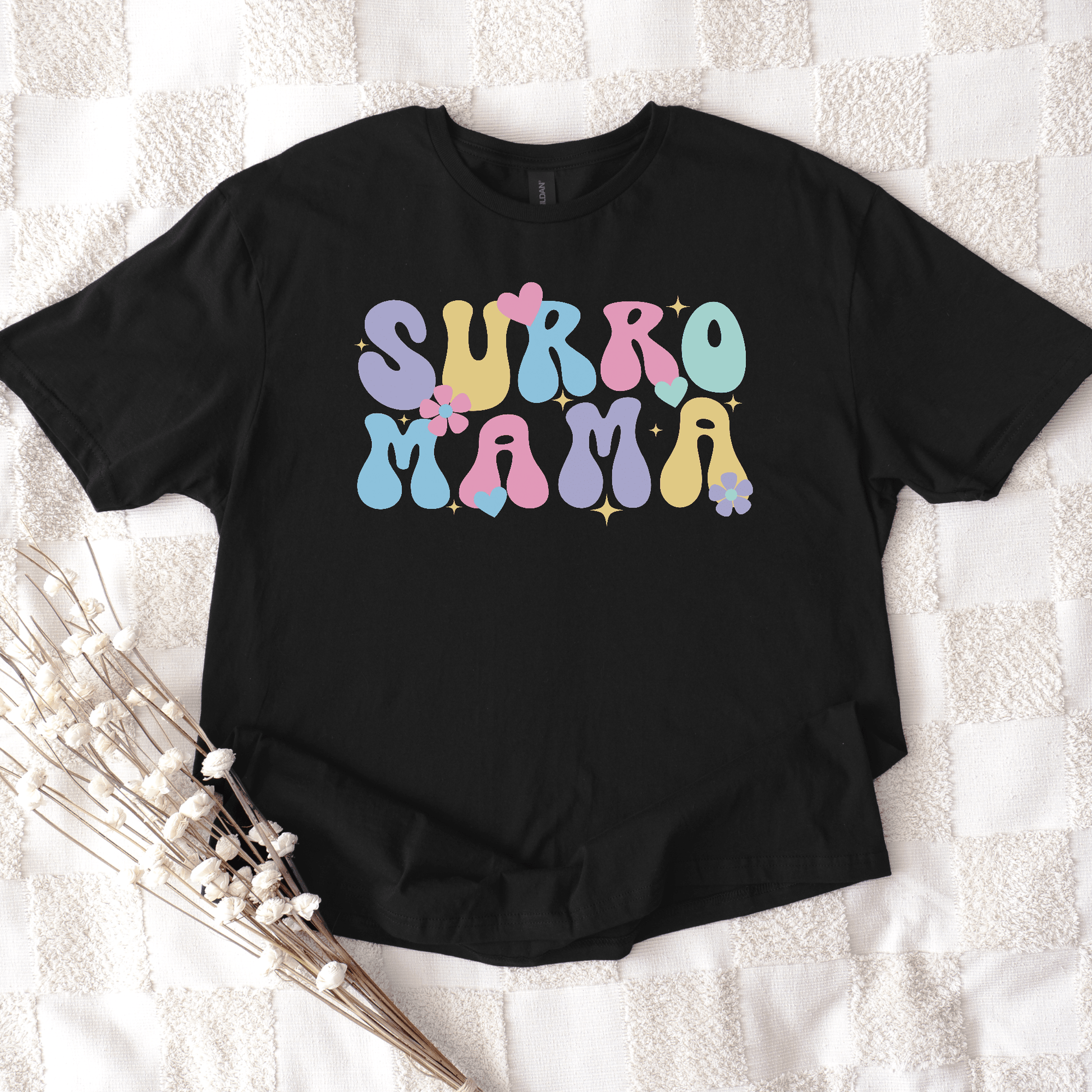 Cute Surrogate Mama Shirt black tee with pastel retro bubble letters and floral accents by Maddy and George Designs