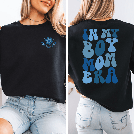 In My Boy Mom Era sweatshirt by Maddy and George Designs black crewneck with small front flower and large blue back text