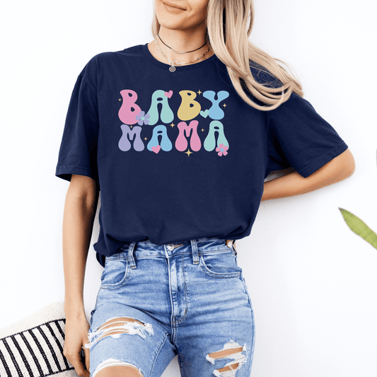 Maddy and George Designs Cute Baby Mama Shirt navy tee with colorful retro bubble lettering worn by woman