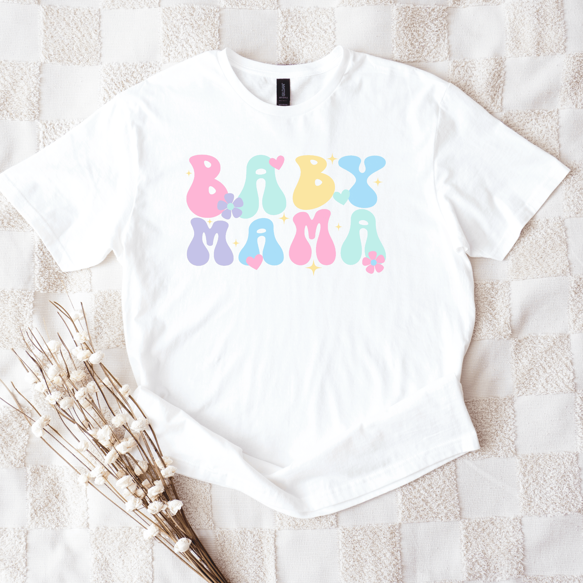 White tee with pastel retro bubble letters reading BABY MAMA on textured blanket Cute Baby Mama Shirt