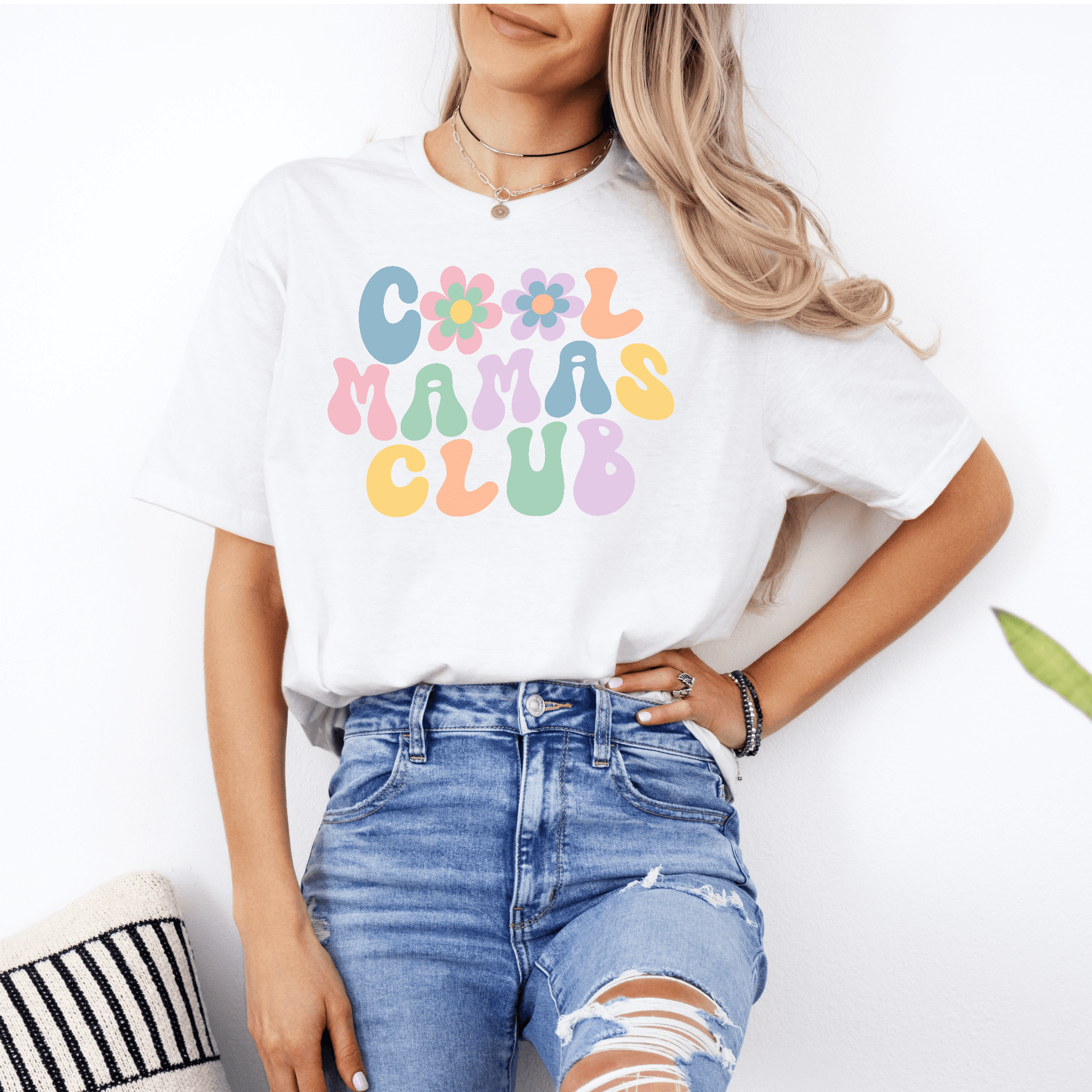 Woman wearing Maddy and George Designs Cool Mamas Club Shirt white tee with pastel retro floral letters